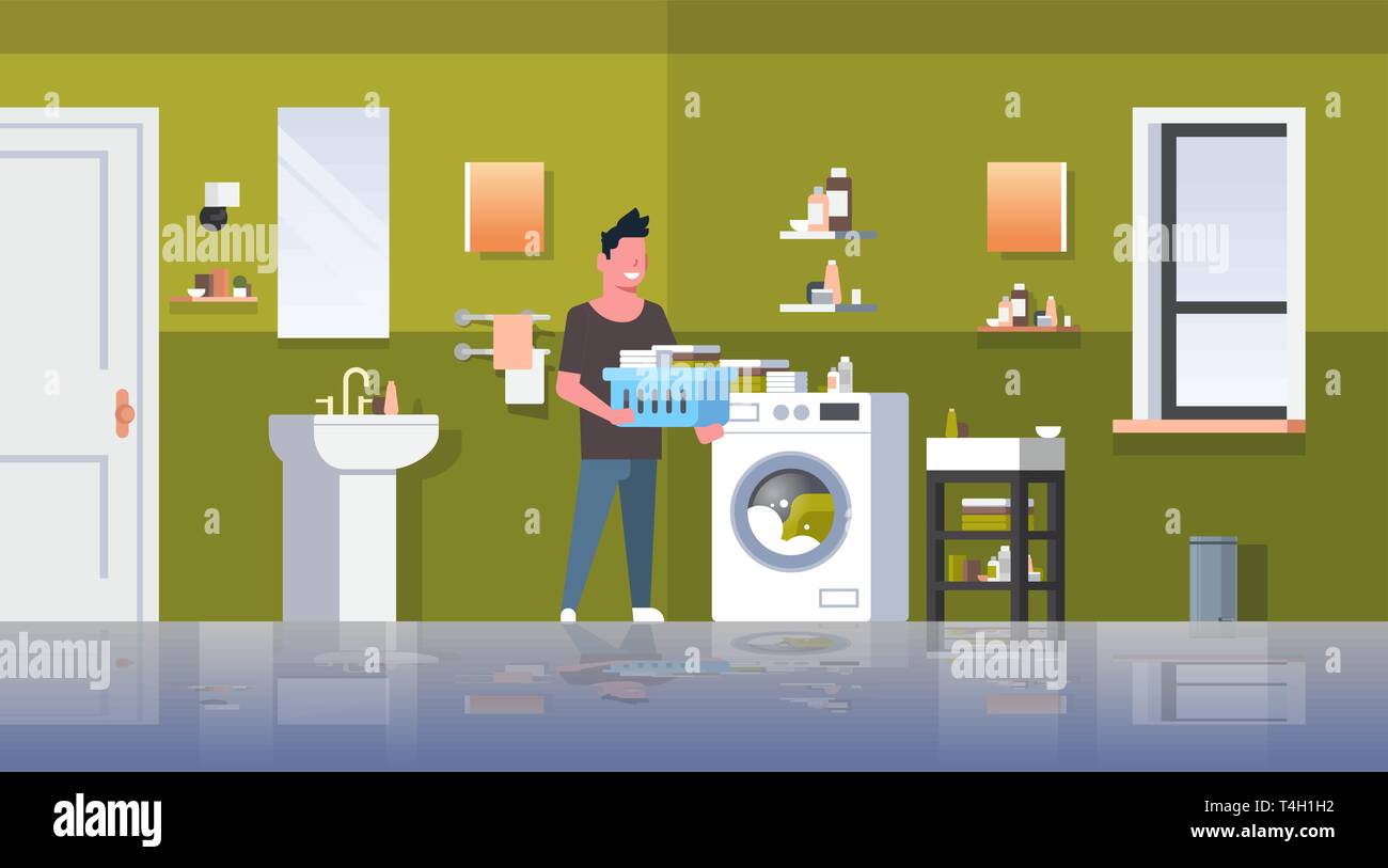 man with clothes basket standing near washing machine guy doing