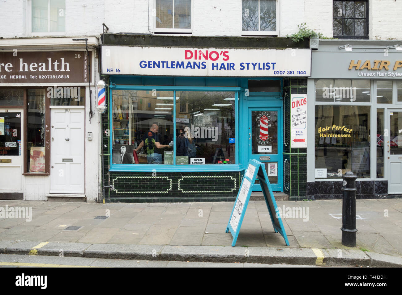 Dino's Gentleman's Hair Stylist shop front in Fulham, London, UK Stock Photo