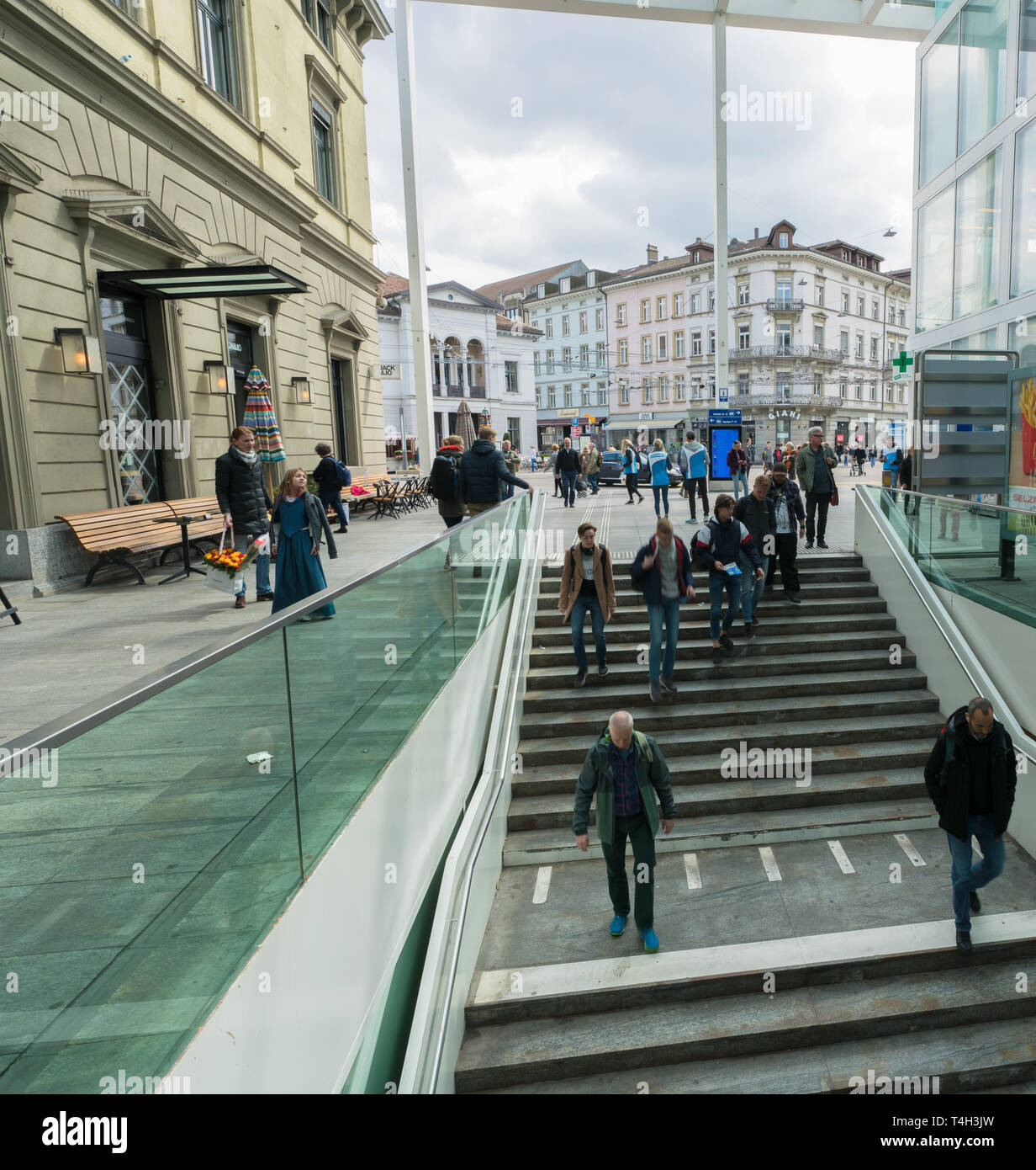Winterthur, ZH / Switzerland - April 8, 2019:  Winterthur train station and trains leaving with commuters and people hurrying to their trains Stock Photo