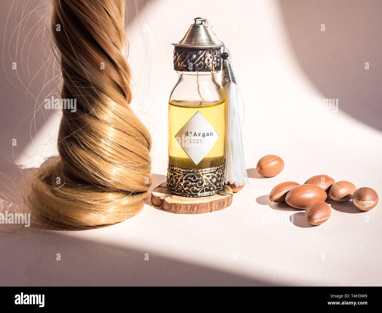 Curll hair of golden hair and decorative bottle with iron embossed in traditional Moroccan style with precious Moroccan argan oil and nuts ander Stock Photo - Alamy Curll hair of golden hair and decorative bottle with iron embossed in traditional Moroccan style with precious Moroccan argan oil and nuts ander Stock Photo - Alamy