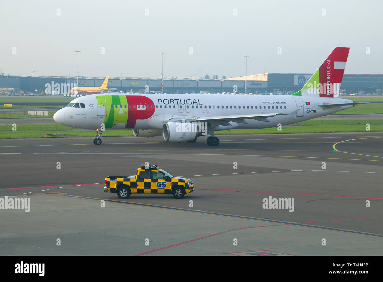 AMSTERDAM, NETHERLANDS - SEPTEMBER 17, 2017: The Airbus A320-214 (CS-TNL) of TAP - Air Portugal airline in the Schiphol Airport of early morning Stock Photo