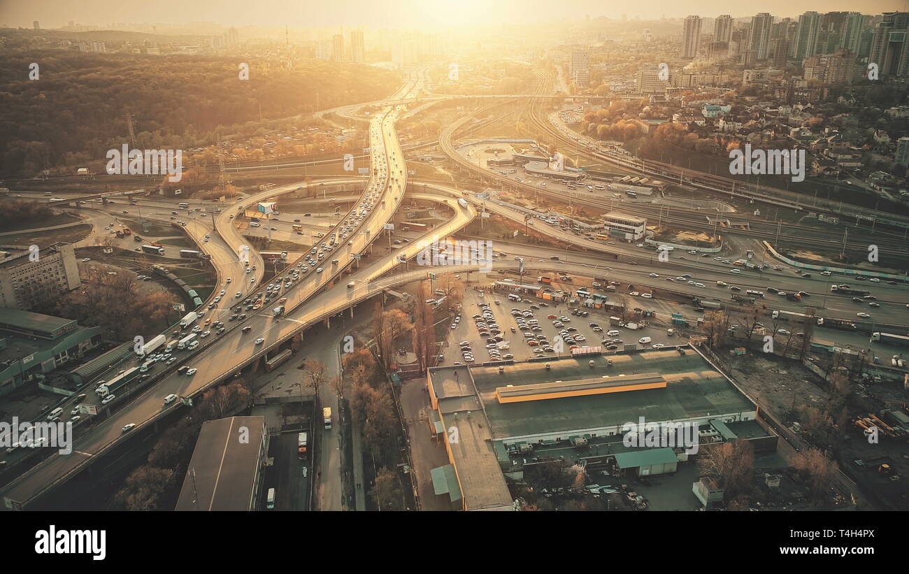 City Road System with Sight Traffic Jam Aerial View. Urban Congested Highway Lane Transport Navigation Scene. Busy Downtown Building Vehicle at Sunset Stock Photo