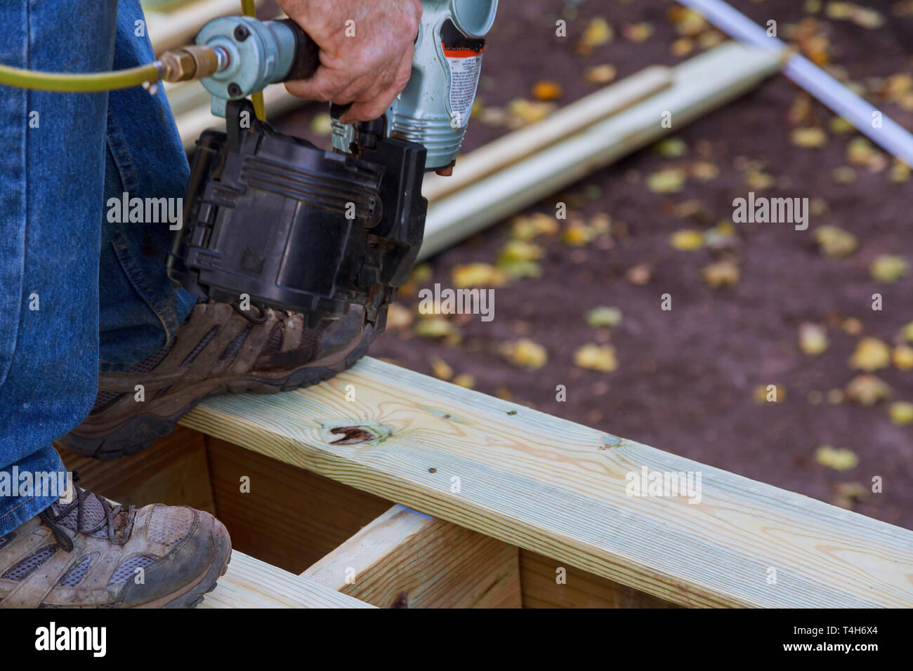 Building a new above ground deck, carpenter installing a wood floor