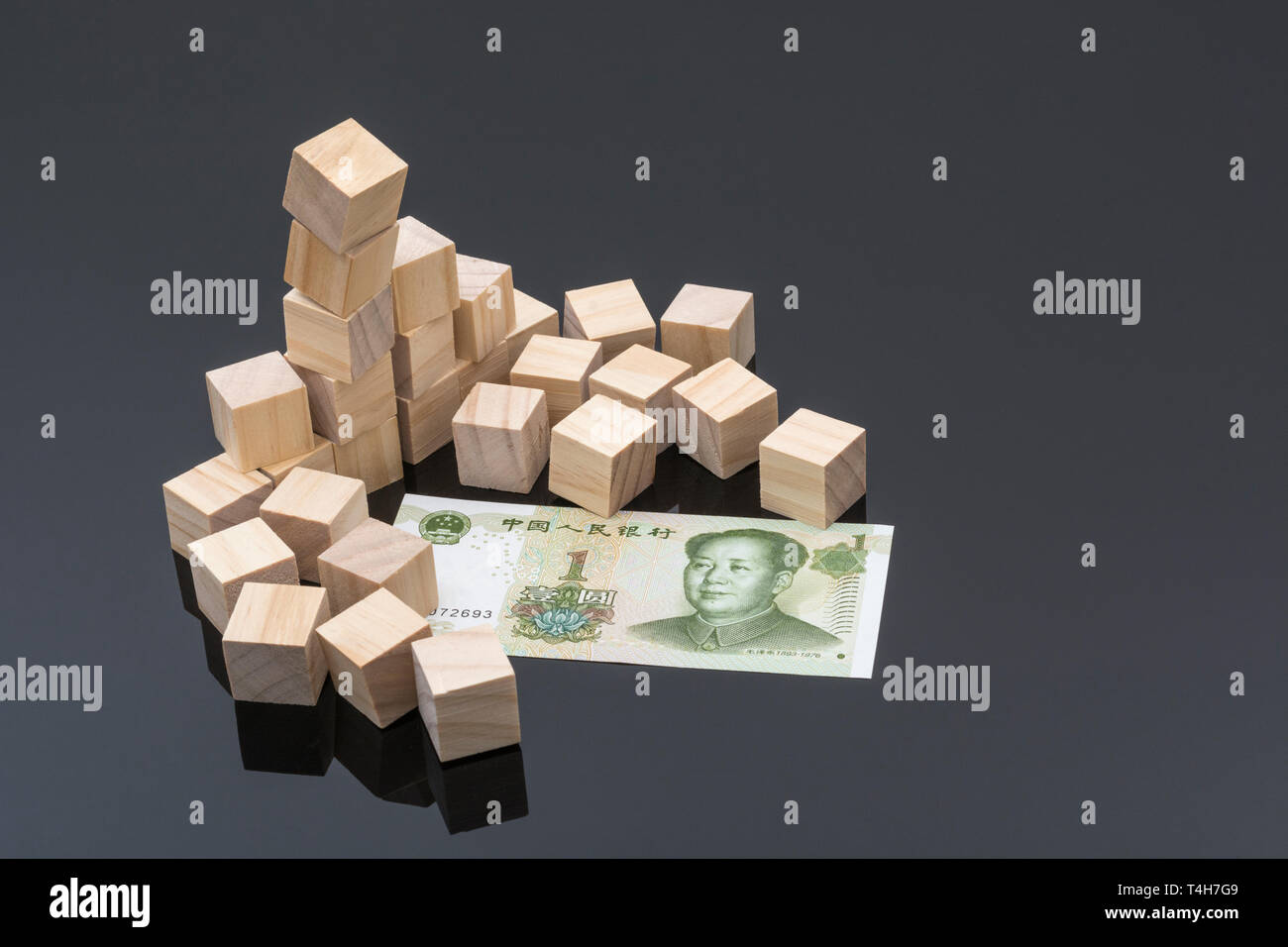 Chinese 1 Yuan bill & scattered wooden bricks. Collapse of Chinese
