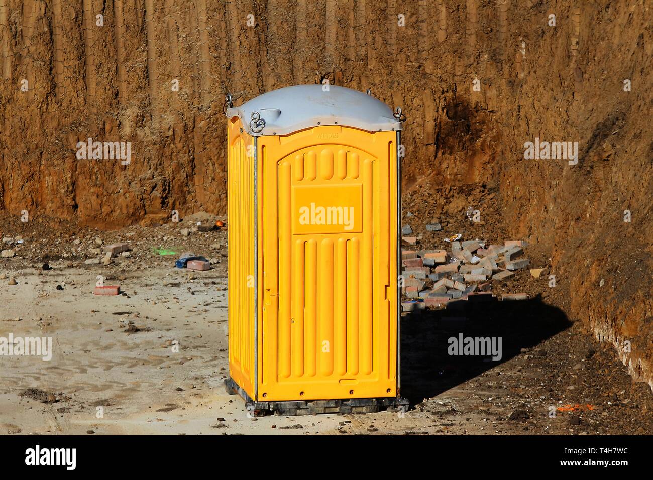 Bucharest, Romania - March 19, 2019: An yellow portable plastic toilet cabin is seen on a building site in Bucharest. This image is for editorial use  Stock Photo