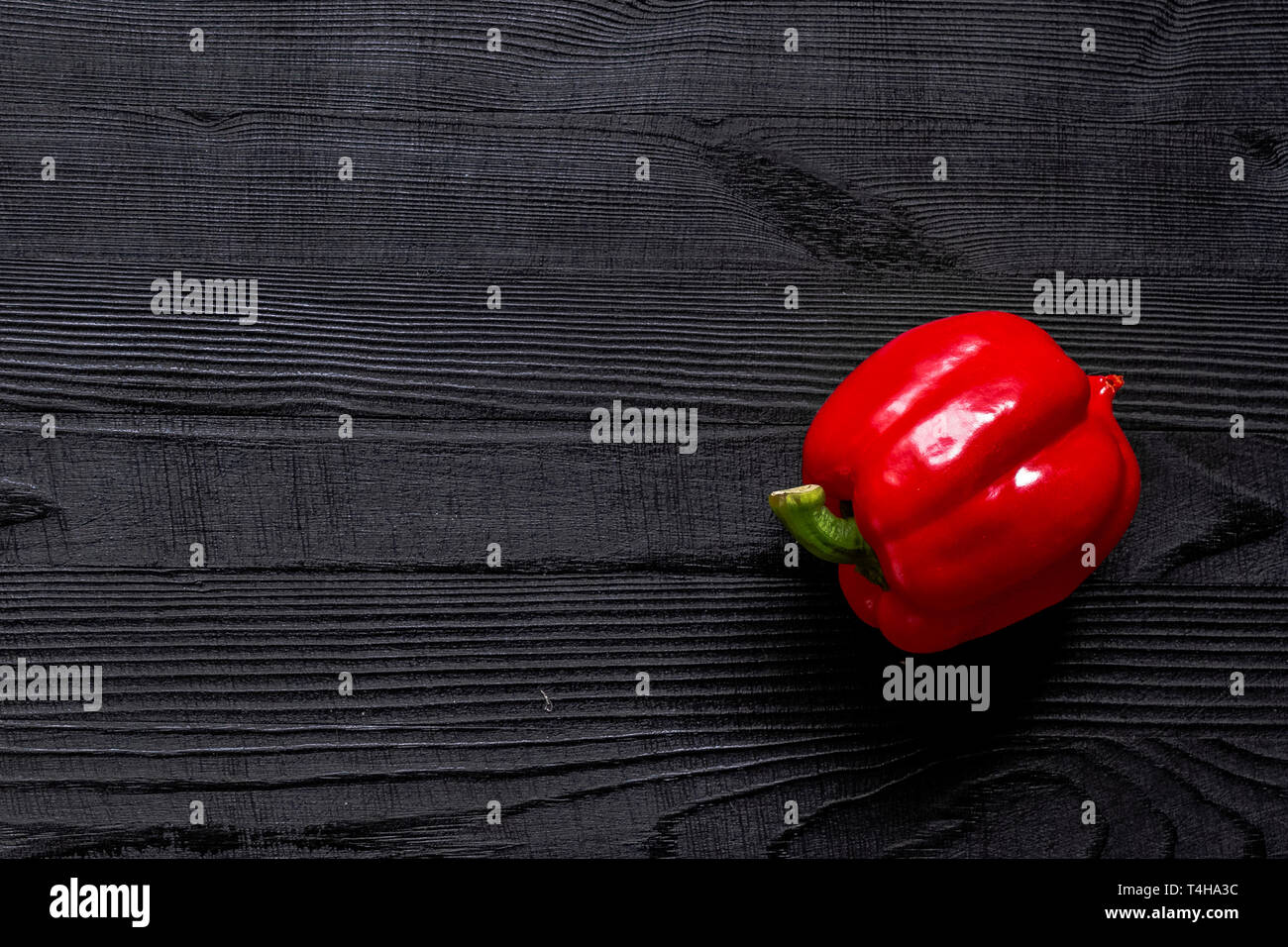 Red sweet bell pepper on black rustic wooden table background Stock ...