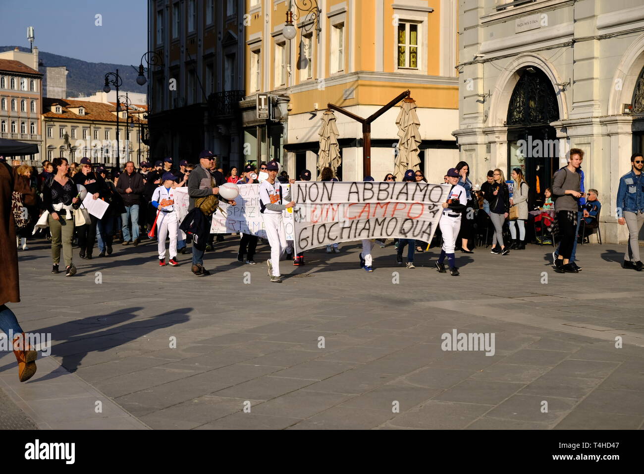 Local kids team protesting on central square that they do not have a playing field for the local baseball team, in Trieste,  Italy Stock Photo