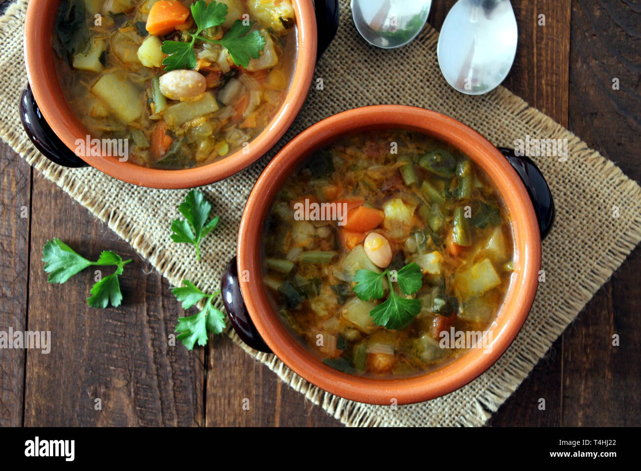 Vegetable soup on the wooden background. Top view. Vegetarian and vegan food. Stock Photo