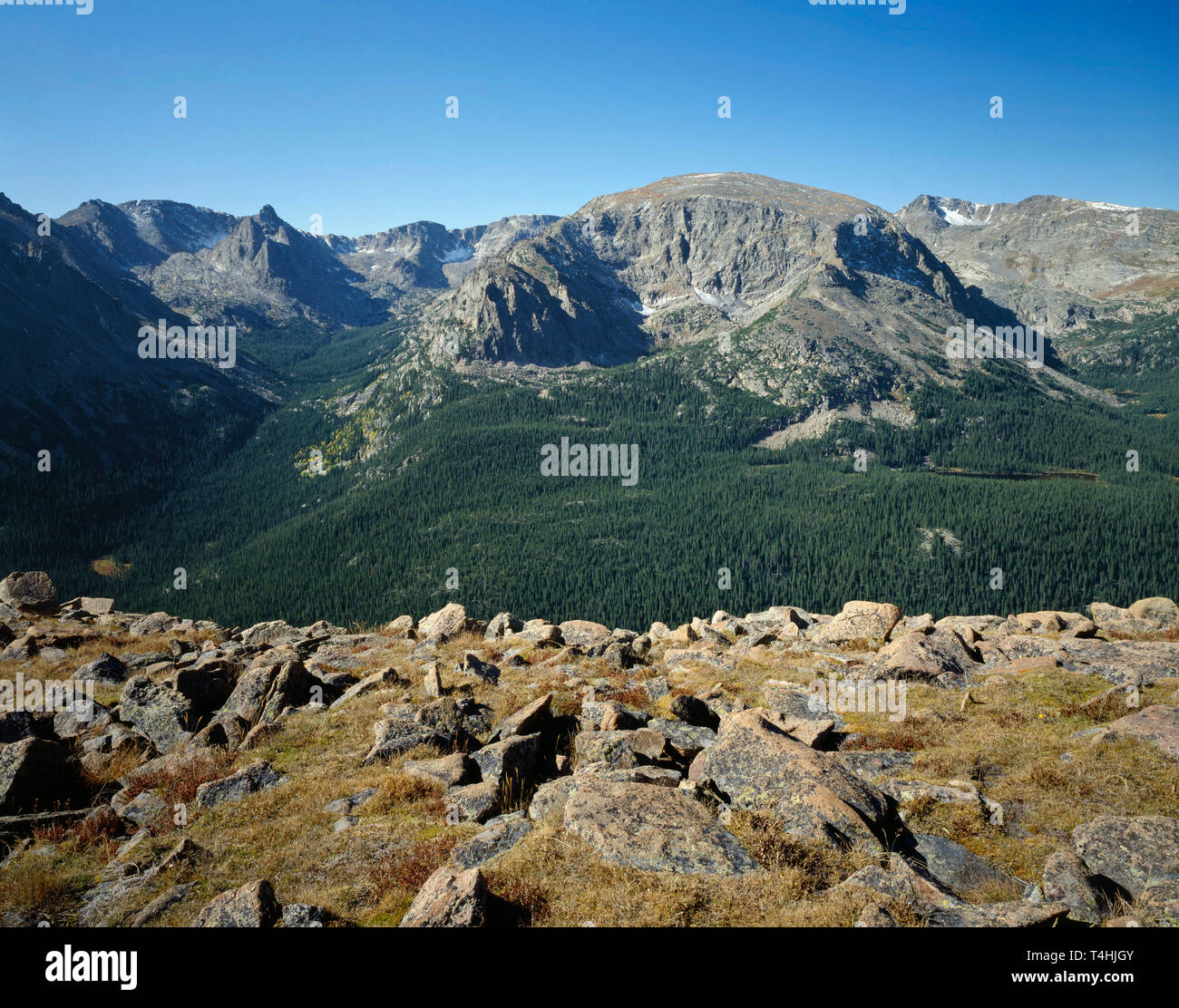 USA, Colorado, Rocky Mountain National Park, Hayden Spire (left), Terra Tomah Mountain (center) and Mt. Ida (right) rise above autumn tundra. Stock Photo