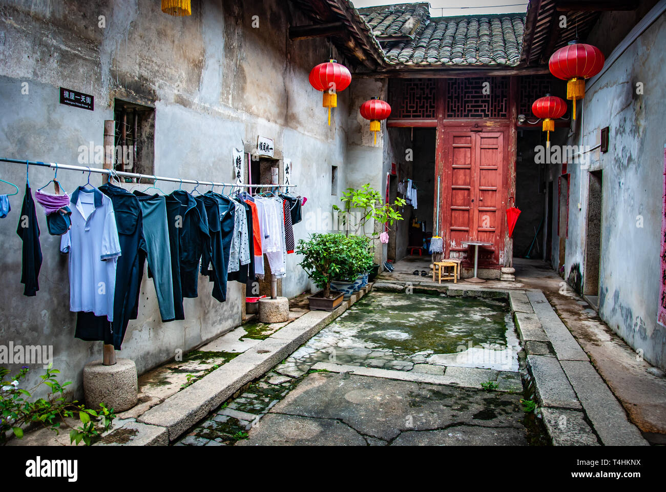 Drying laundry, courtyard of a traditional Chinese house. Laundry hangs to dry outside, home with tile roof. Red lanterns, China, Interiors, poverty Stock Photo