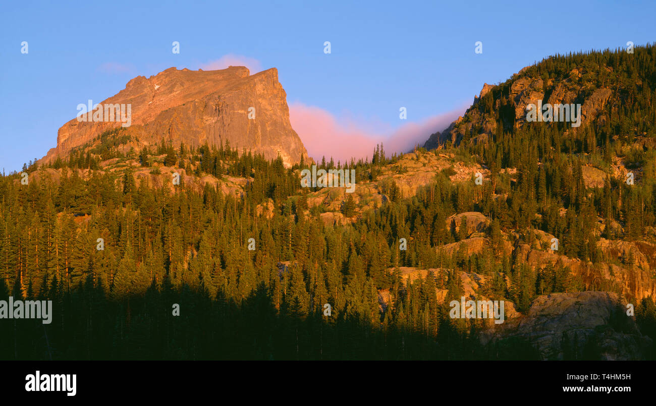 USA, Colorado, Rocky Mountain National Park; Sunrise warms Hallett Peak and forest above Bear Lake. Stock Photo