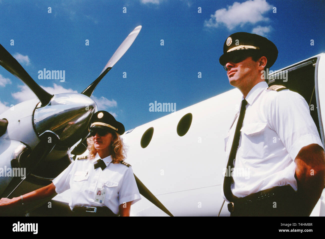Pilot and His Female CoPilot Stand Outside their Commuter Aircraft