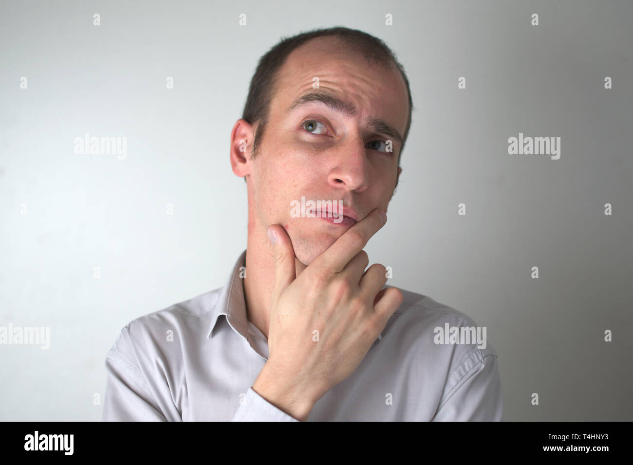 Sudio shot of a man with a thoughtful expression. Stock Photo