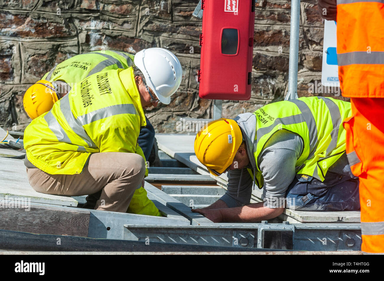 Schull, West Cork, Ireland. 16th Apr, 2019. West Cork Civil Engineering were given the task of refloating the €600,000 Schull pontoon, ready for the season.  Workers are seen preparing a piece of the pontoon onto the slipway, ready to be floated into the water. Credit: Andy Gibson/Alamy Live News. Stock Photo