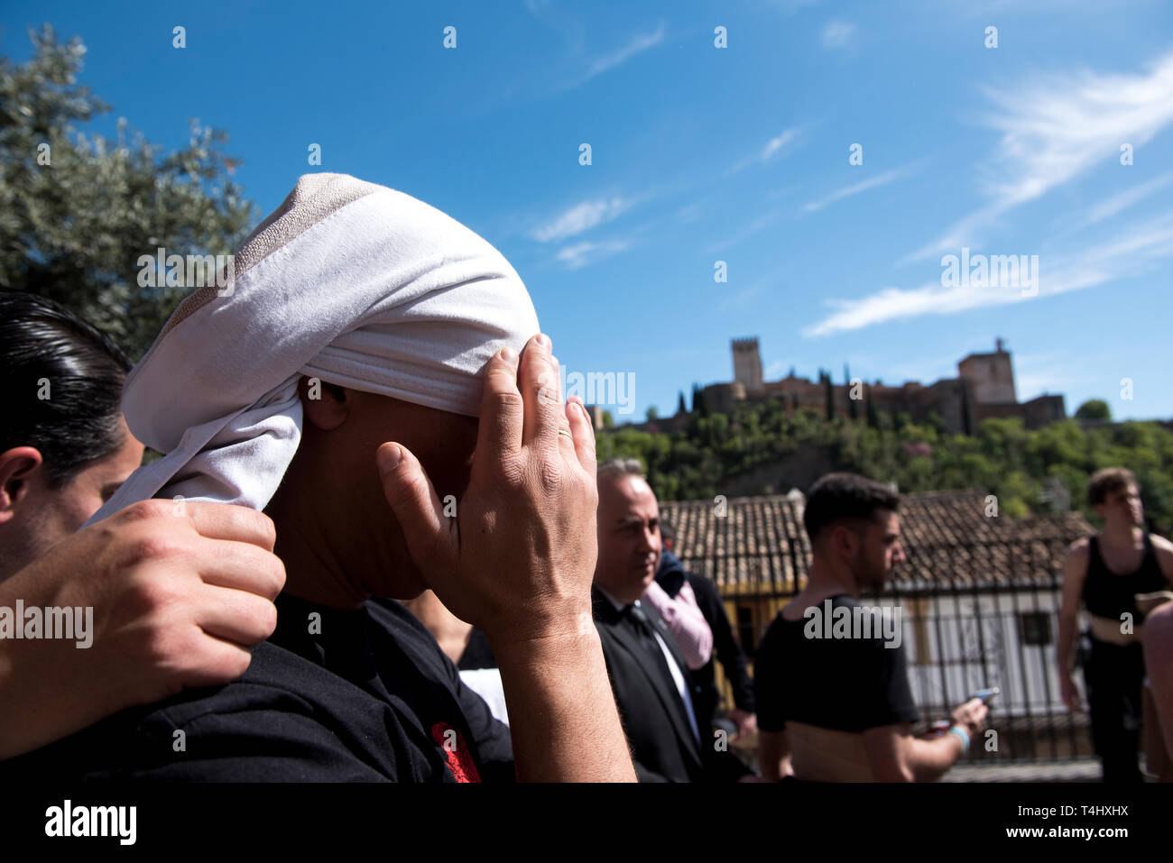 A costalero from 'Via Crucis' brotherhood is seen preparing his protection before the holy Tuesday procession. Holy week is one of the most important religious tradition in Andalusia. Stock Photo