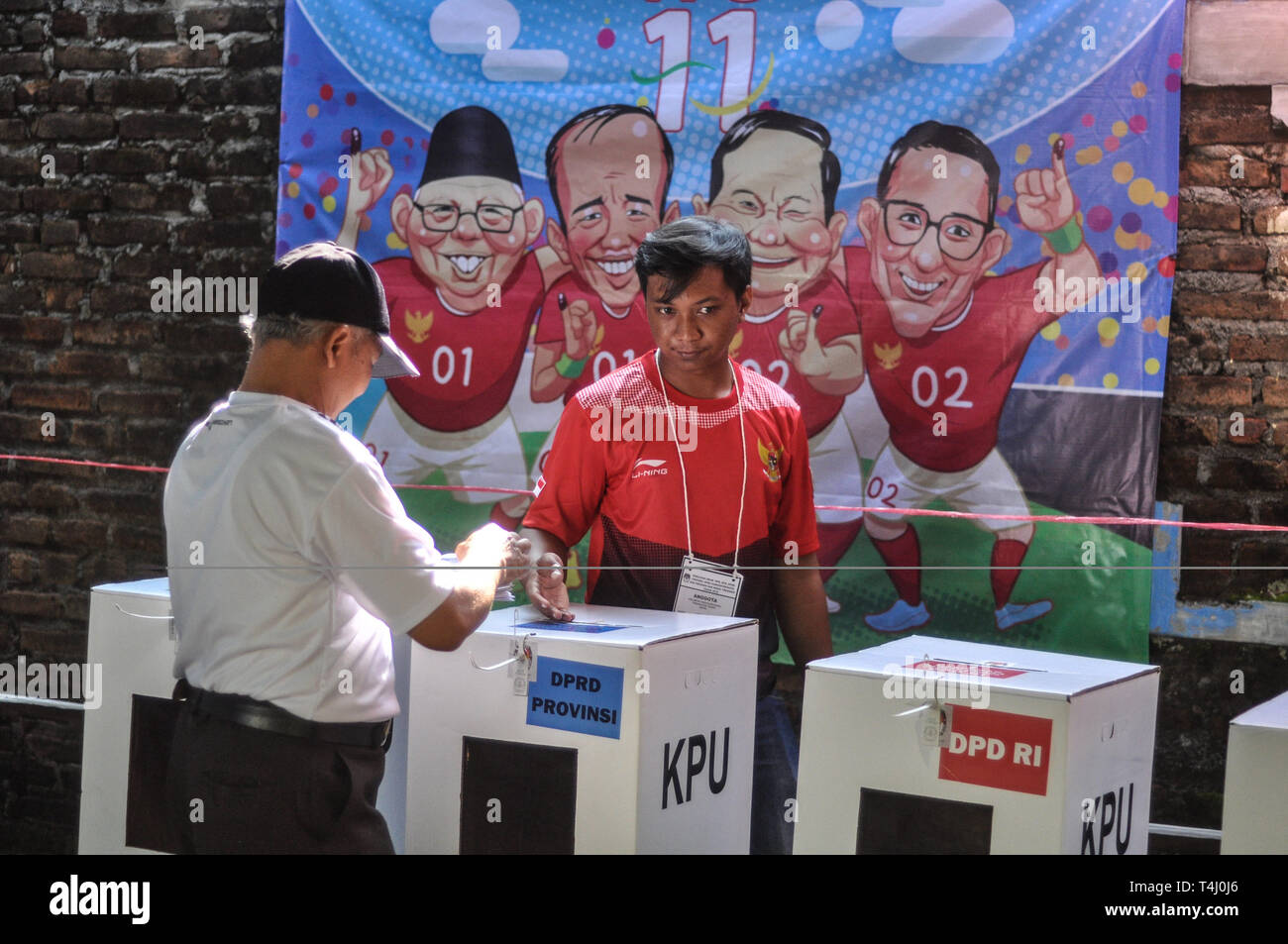 Yogyakarta, INDONESIA. 17th Apr, 2019. Voters cast their votes as caricatures of presidential candidates and their candidate pairs hung on the walls at polling stations in Yogyakarta, Indonesia, Wednesday, April 17 2019. Millions of Indonesians voted in presidential and legislative elections with former presidential candidates Joko Widodo and Prabowo Subianto Suharto's son-in-law led Indonesia for 32 years. Credit: Slamet Riyadi/ZUMA Wire/Alamy Live News Stock Photo