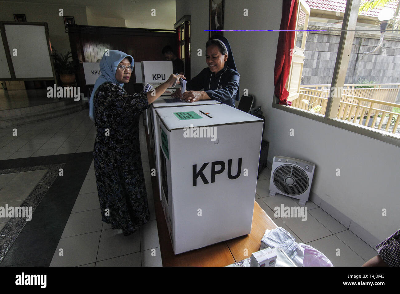 Yogyakarta, INDONESIA. 17th Apr, 2019. A Catholic nun helps an elderly Muslim woman to vote in a polling station in a monastery in Yogyakarta, Indonesia, Wednesday, April 17 2019. Millions of Indonesians vote in presidential and legislative elections with former presidential candidates Joko Widodo and former Prabowo Subianto Soeharto's son-in-law general who led Indonesia for 32 years. Credit: Slamet Riyadi/ZUMA Wire/Alamy Live News Stock Photo
