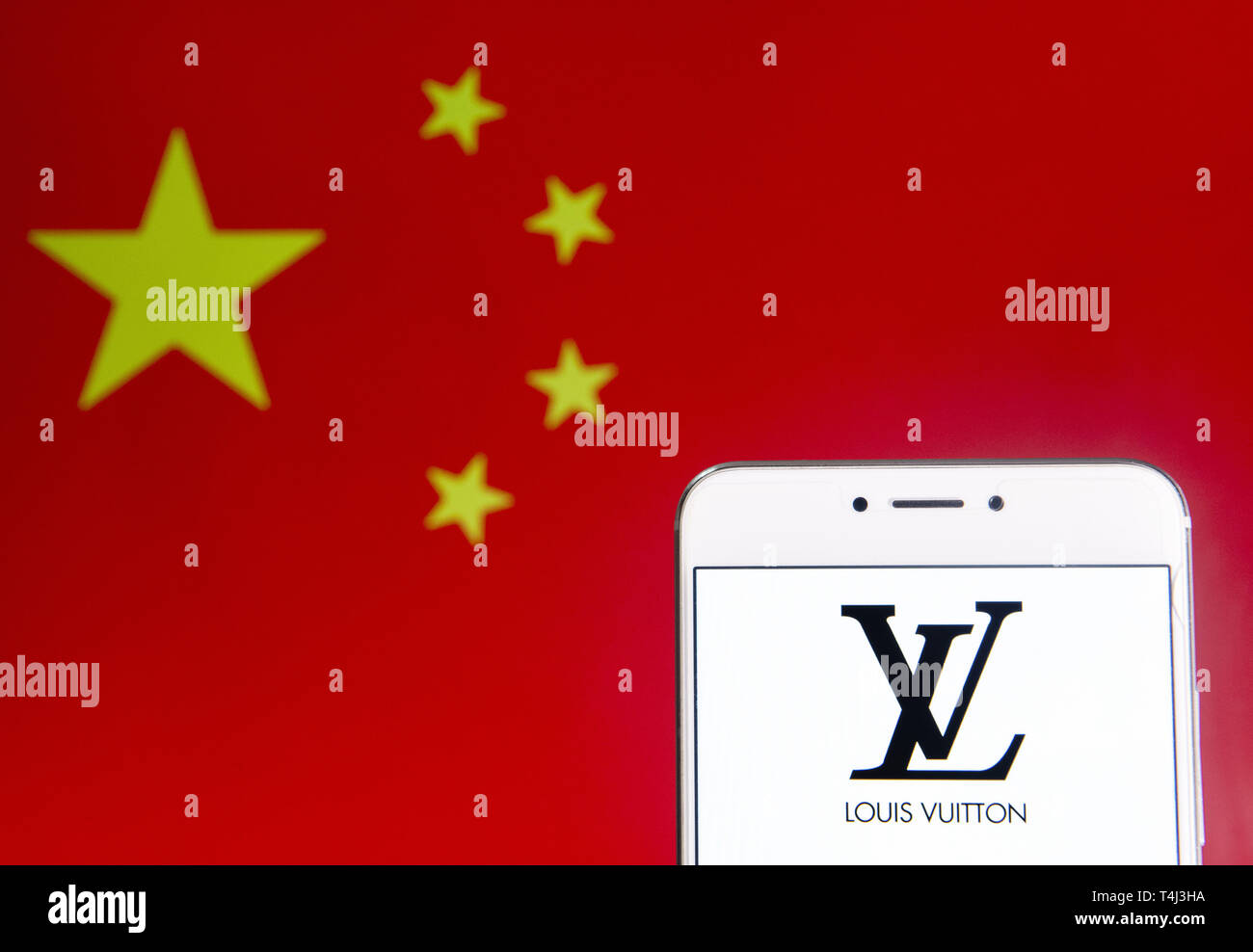 April 6, 2019 - Hong Kong - In this photo illustration a French luxury fashion brand Louis Vuitton logo is seen on an Android mobile device with People's Republic of China flag in the background. (Credit Image: © Budrul Chukrut/SOPA Images via ZUMA Wire) Stock Photo