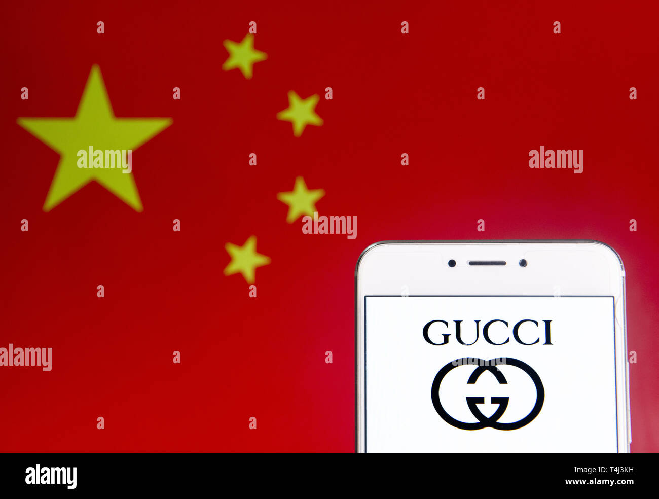 April 6, 2019 - Hong Kong - In this photo illustration a Italian luxury  fashion brand Gucci logo is seen on an Android mobile device with People's  Republic of China flag in