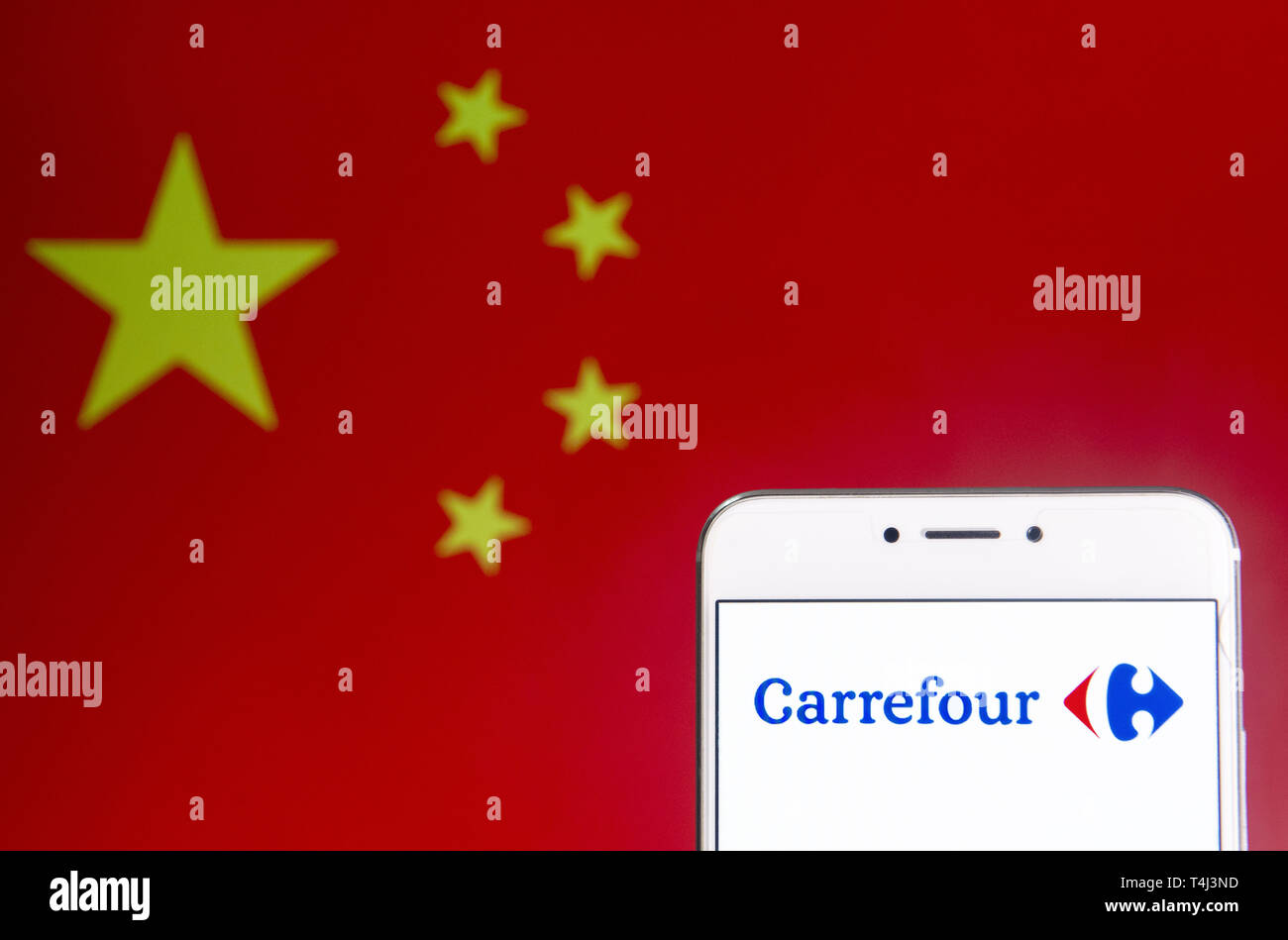 April 6, 2019 - Hong Kong - In this photo illustration a French multinational supermarket chain, Carrefour, logo is seen on an Android mobile device with People's Republic of China flag in the background. (Credit Image: © Budrul Chukrut/SOPA Images via ZUMA Wire) Stock Photo