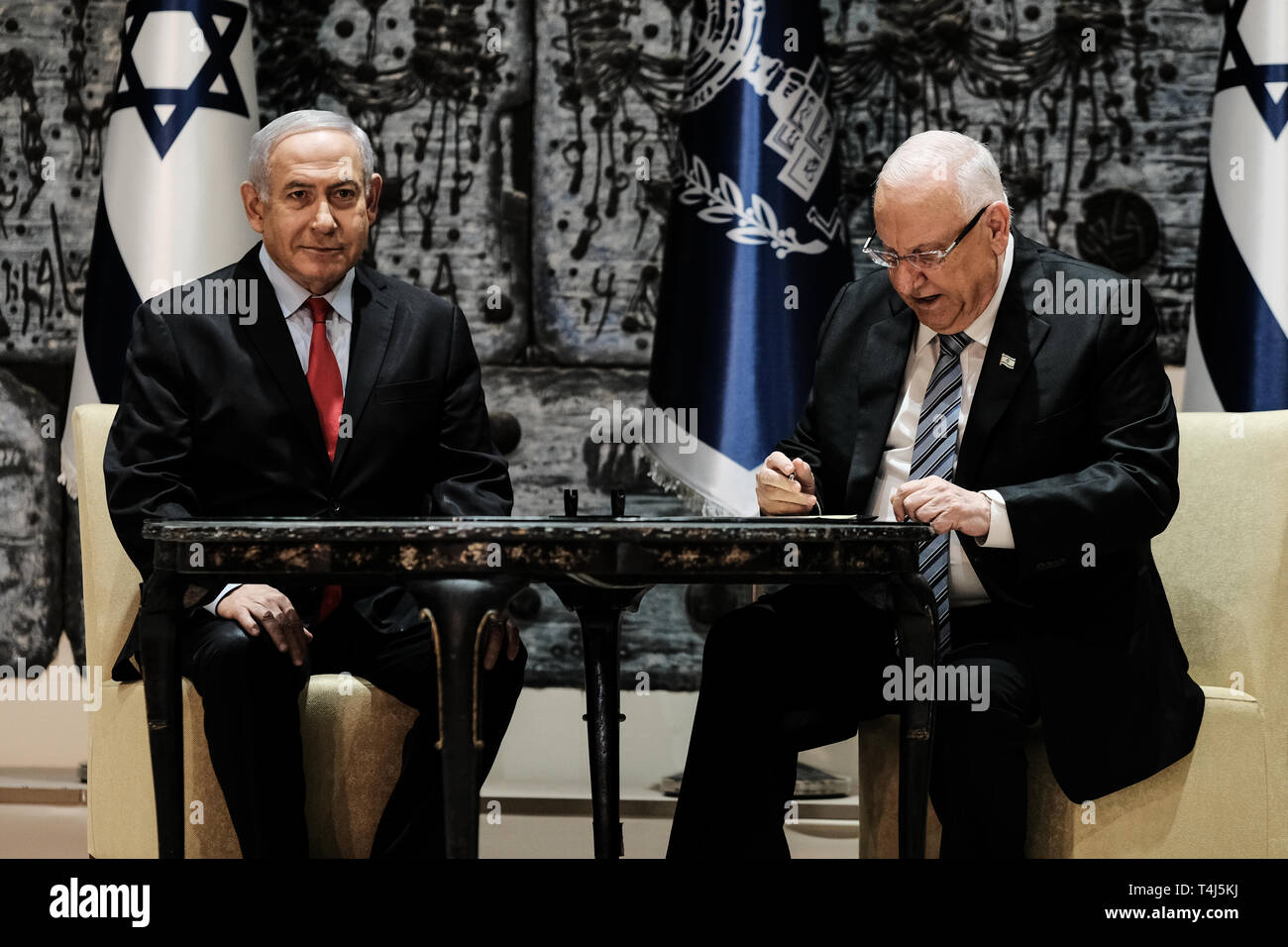 Jerusalem, Israel. 17th April, 2019.  Israeli President REUVEN RIVLIN (R) signs a letter of appointment tasking incumbent Prime Minister BENJAMIN NETANYAHU (L) with formation of the next coalition government following April 9th, 2019 elections. Netanyahu's Likud party won 35 of 120 parliament seats in a tie with Blue and White party but has best chance to succeed in forming a coalition based on President's consultations with representatives of all elected parties. Credit: Nir Alon/Alamy Live News Stock Photo