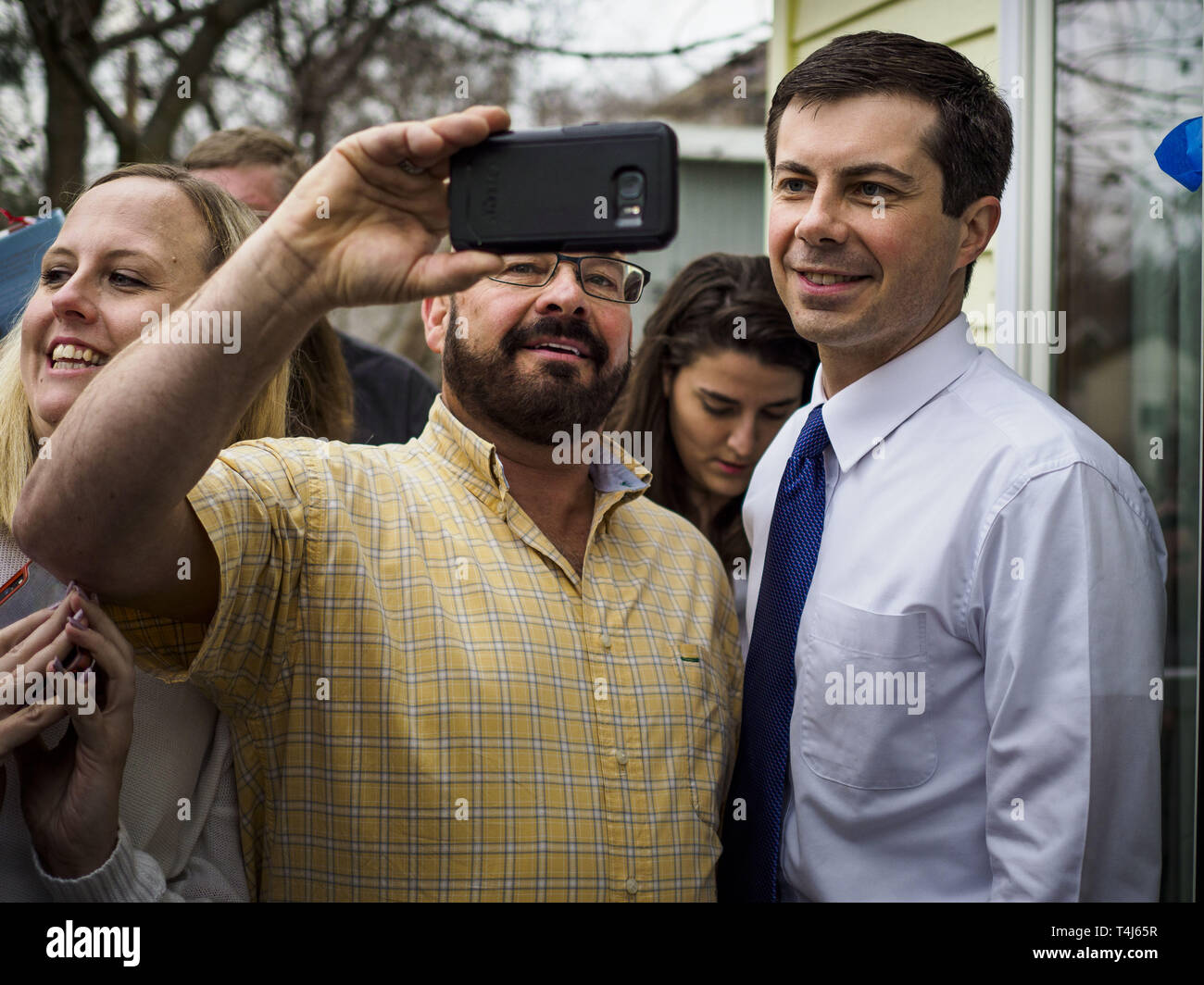 April 17, 2019 - Marshalltown, Iowa, U.S - Mayor PETE BUTTIGIEG poses for a selfie with a voter after a meet and greet at home in Marshalltown, Iowa. People came from as far away as Minneapolis, Minnesota and Rockford, Illinois to meet the mayor of South Bend, Indiana. ''Mayor Pete, '' as he goes by, declared his candidacy to be the Democratic nominee for the US Presidency on April 14. Buttigieg is touring Iowa this week. Iowa traditionally hosts the the first selection event of the presidential election cycle. The Iowa Caucuses will be on Feb. 3, 2020. Credit: ZUMA Press, Inc./Alamy Live News Stock Photo