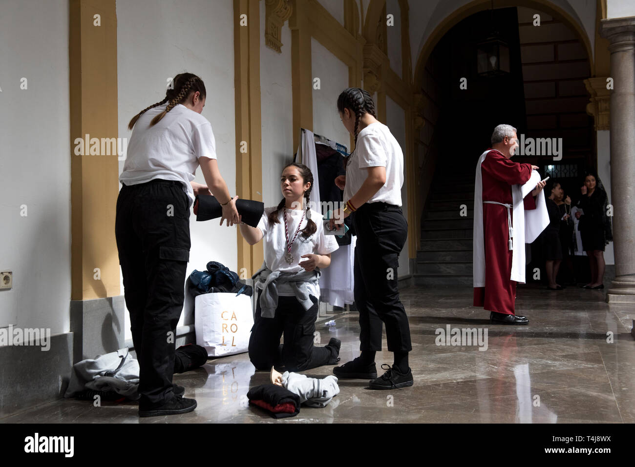 Costaleras from 'Estudiantes' brotherhood are seen preparing for the Holy Wednesday procession in Granada. Every year thousands of christians believers celebrates the Holy Week of Easter with the crucifixion and resurrection of Jesus Christ. Stock Photo