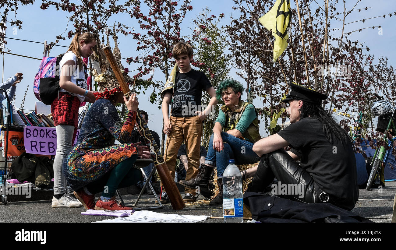 Protesters speaking on the bridge during the Extinction Rebellion strike in London.  Extinction Rebellion protesters have blocked five central London landmarks to protest against the government inaction on climate change. Stock Photo