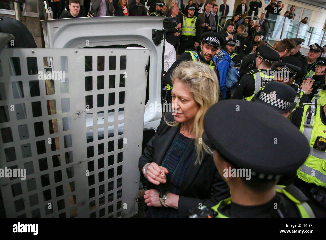 British Transport Police officers are seen arresting an environmental activist from the Extinction Rebellion campaign group at Canary Wharf station during the third day of the Extinction Rebellion Climate Change protest.  The group is demanding decisive action from the UK Government on the environmental crisis. Stock Photo