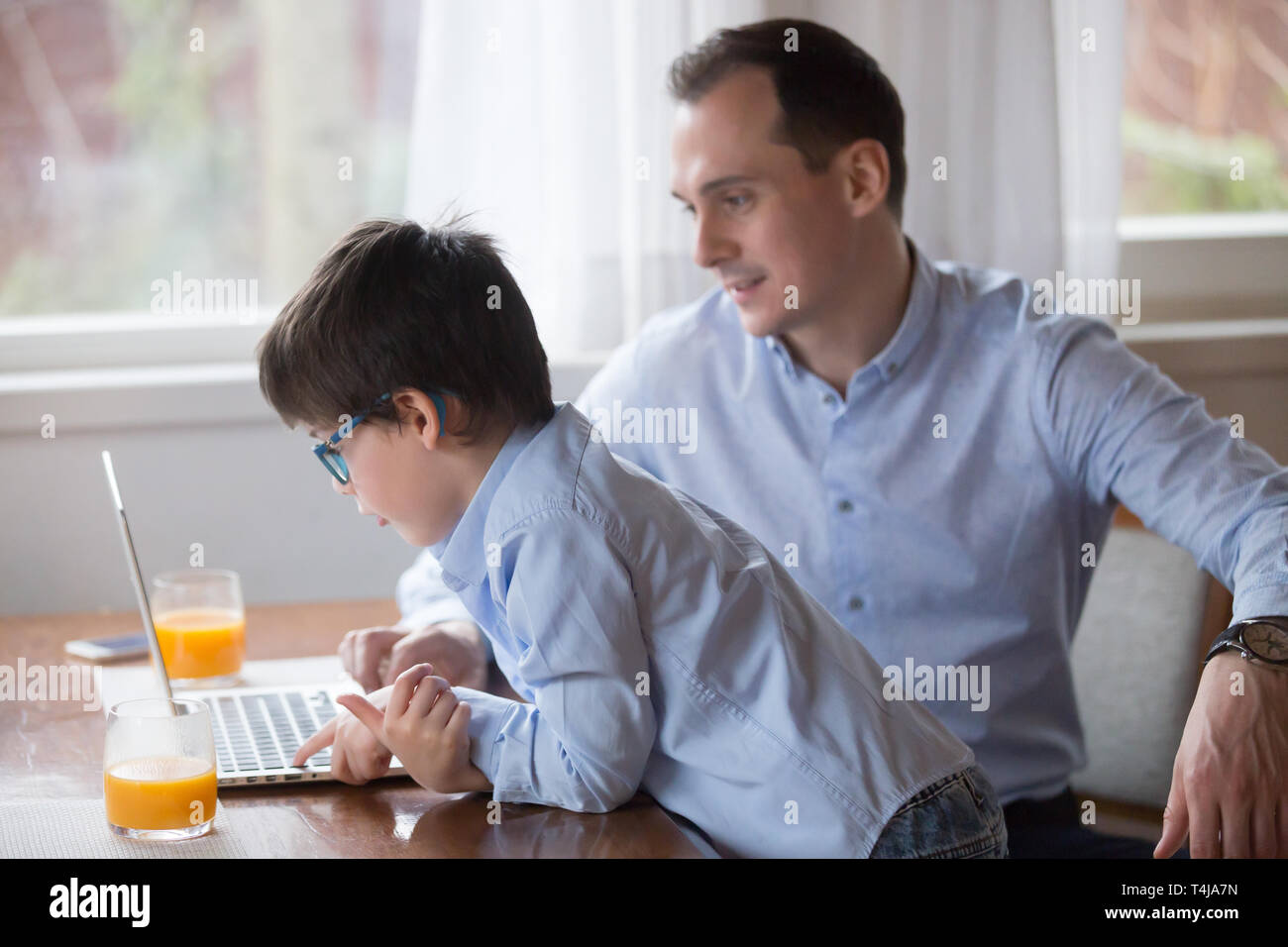 Father And Son Playing Computer Game On Weekend At Home Stock Photo Alamy