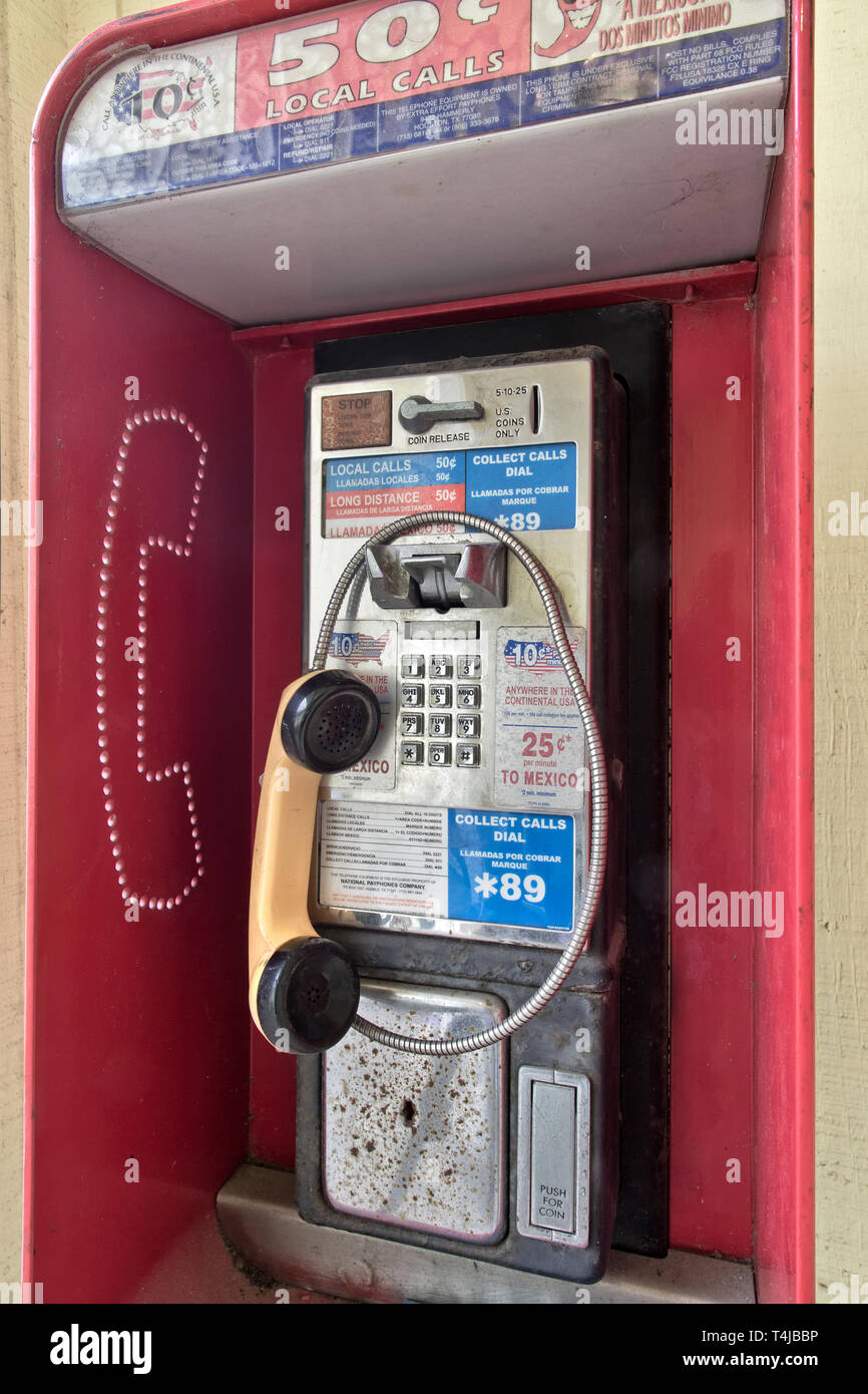 Classic Coin operated public pay telephone with receiver, pushbutton, coin release slot. Stock Photo