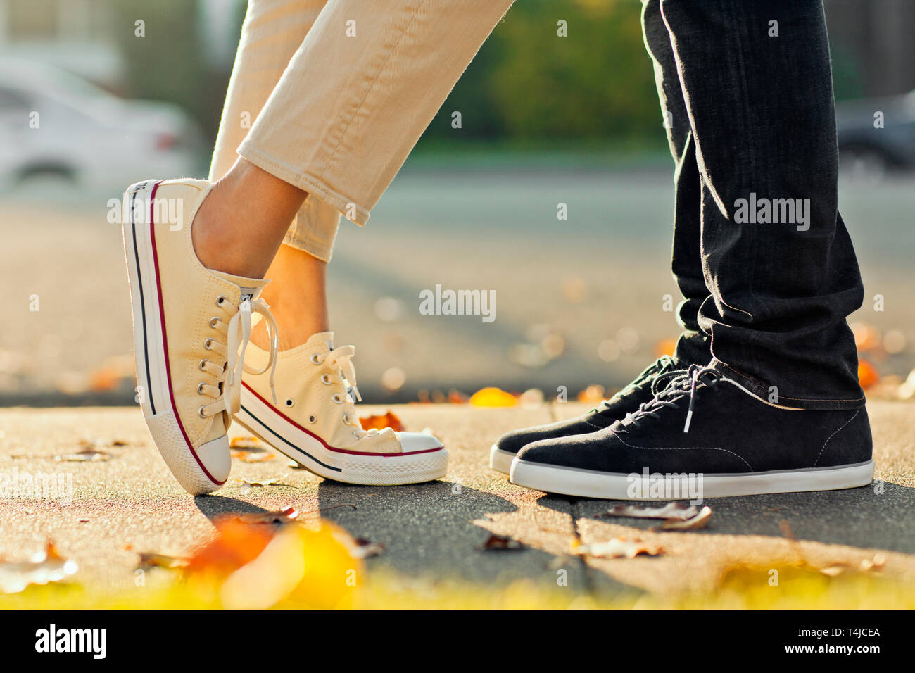 Close up of couple's feet facing each other on the footpath Stock Photo