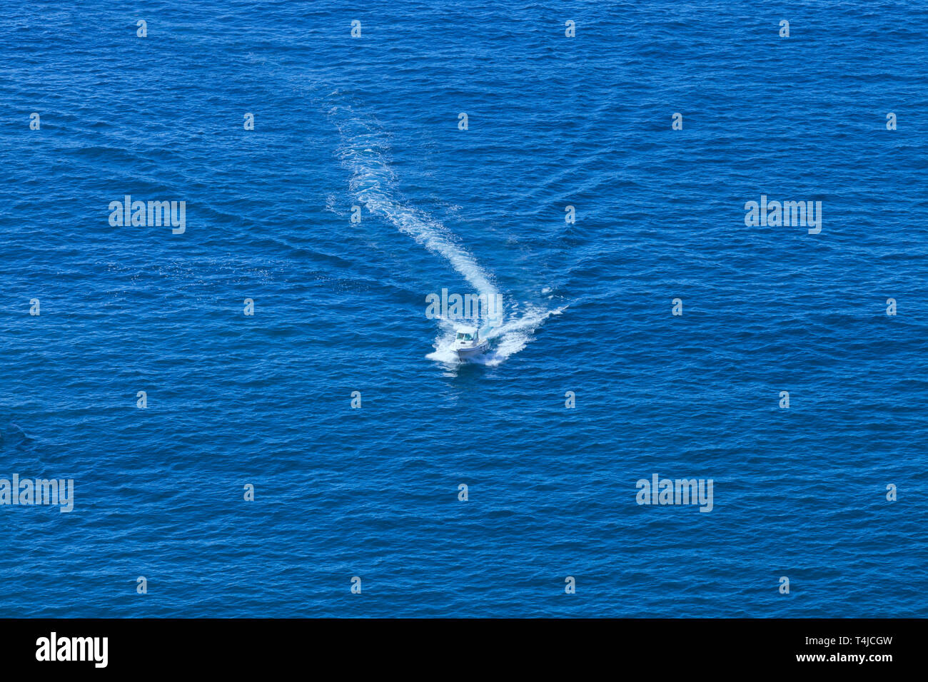 Aerial view of motor boat cruising through calm sea waters Stock Photo ...