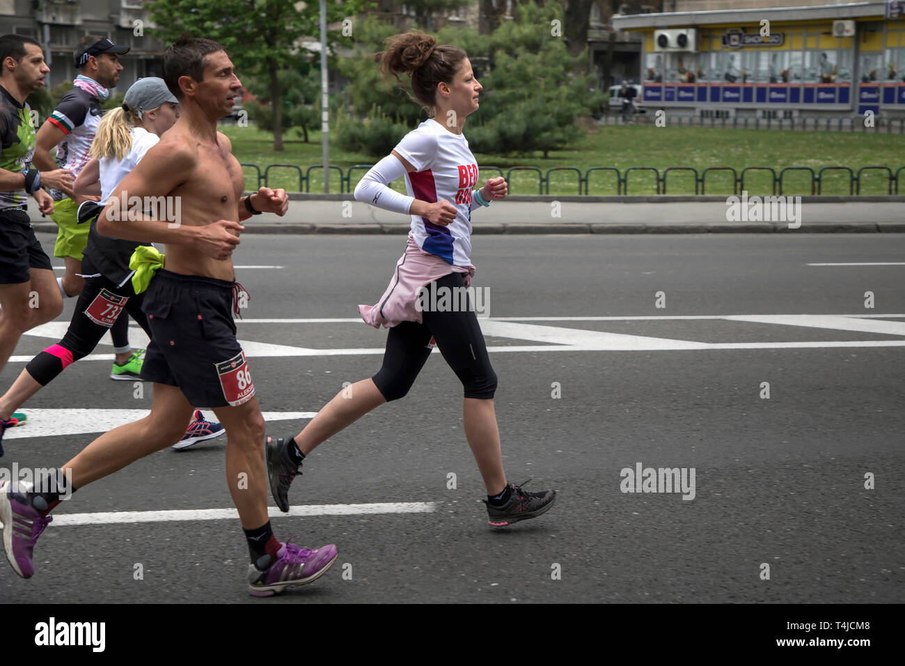 Serbia, April 14th 2019: Group of the 32nd Belgrade Marathon participants running down the Karadjordjeva Street in Zemun Stock Photo