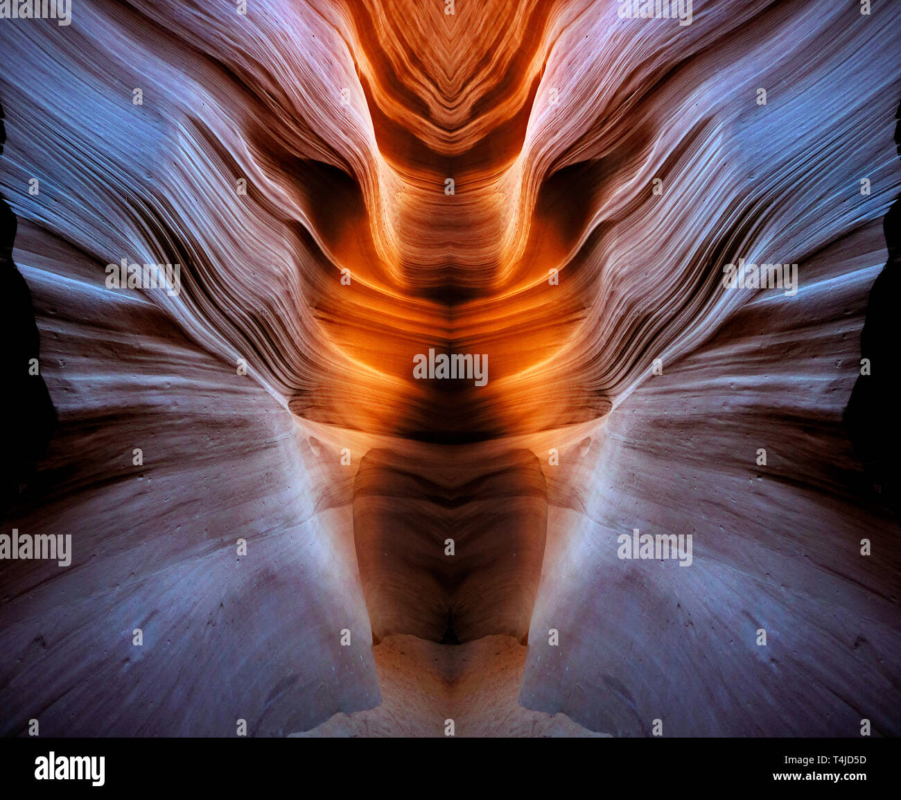 The smooth flowing slot canyons of Arizona. This Image was created by combining two symmetrical images, reversing one half to produce a unique design. Stock Photo