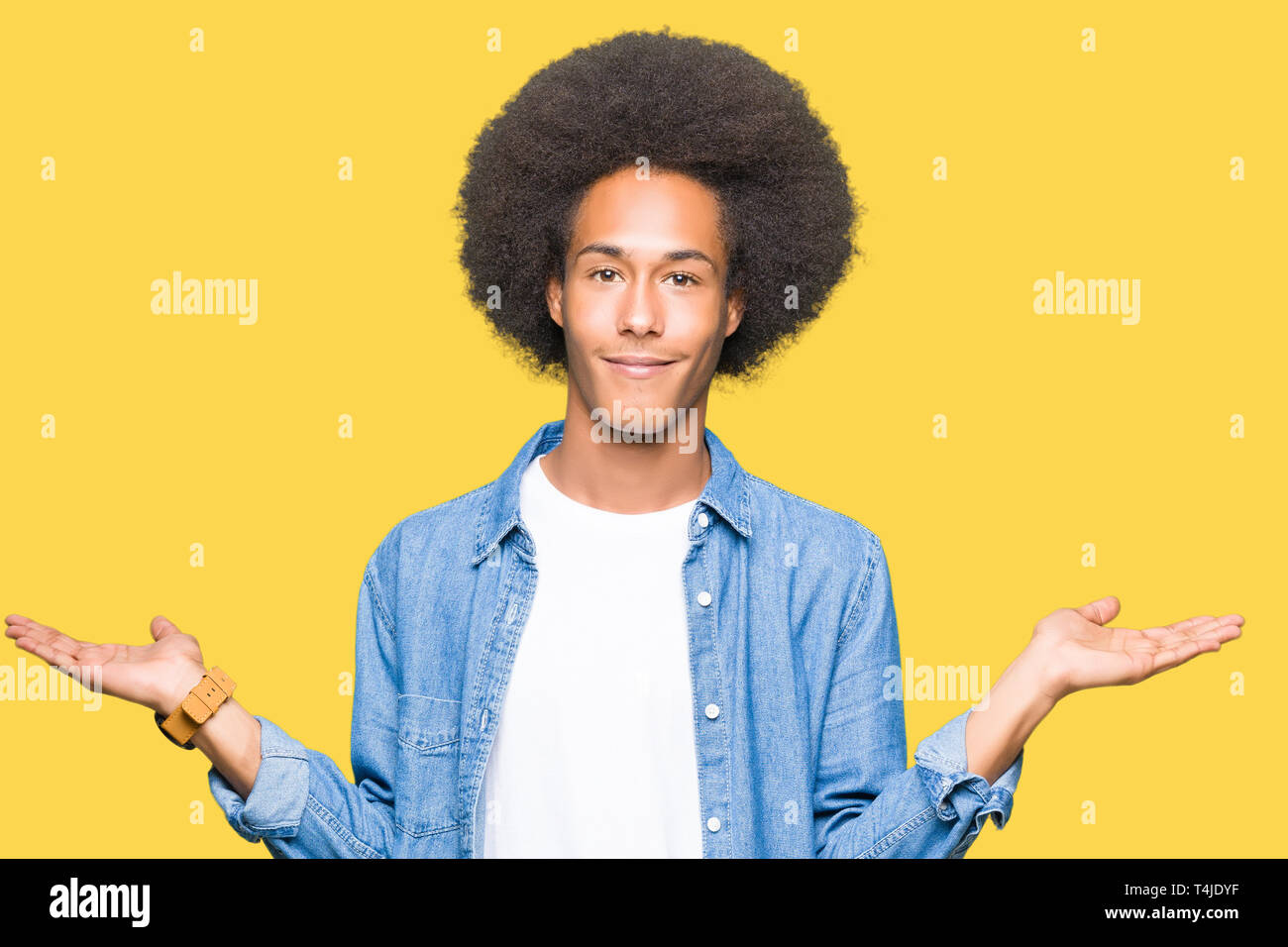 Young african american man with afro hair Smiling showing both hands ...