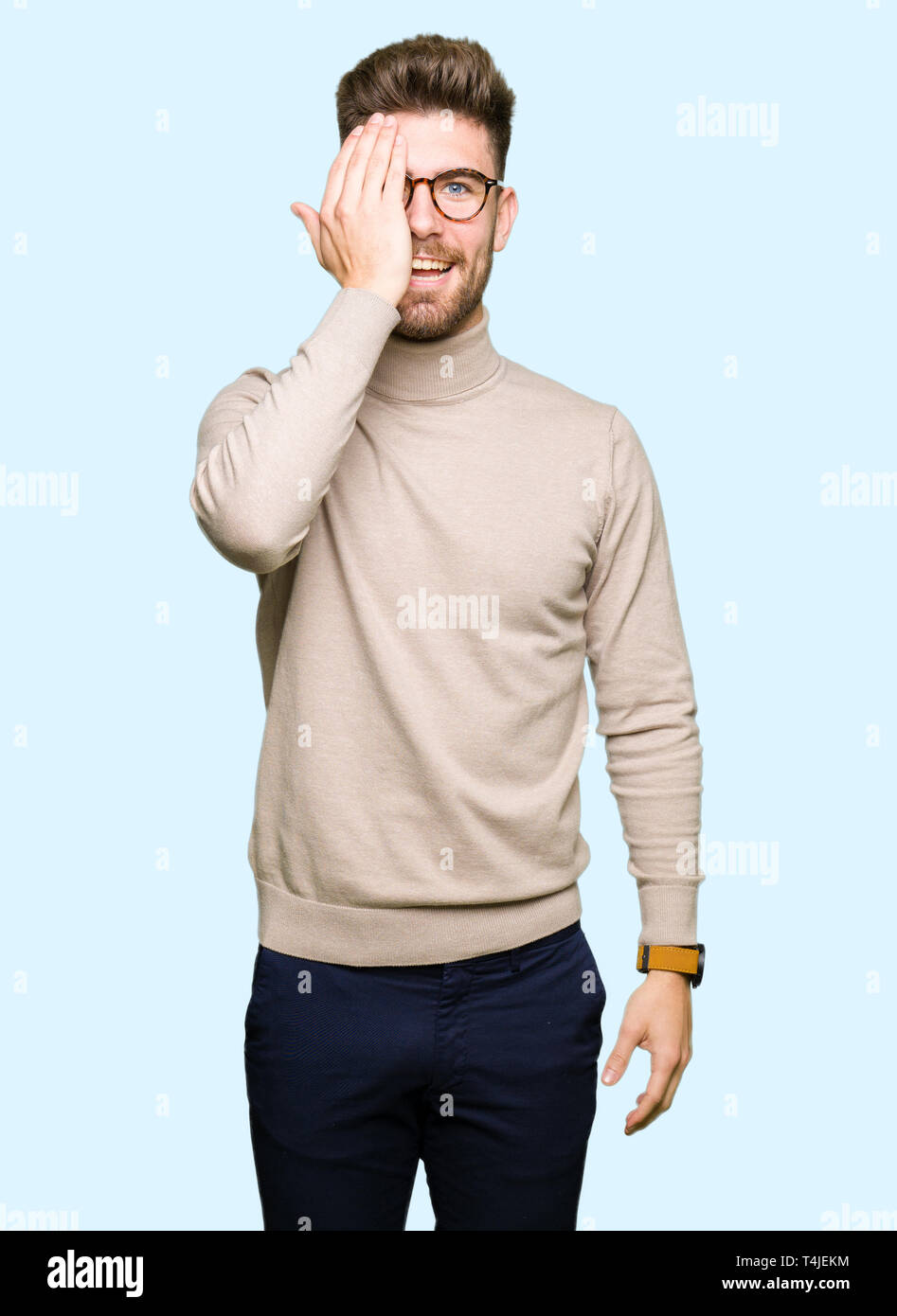 Young handsome business man wearing glasses covering one eye with hand ...