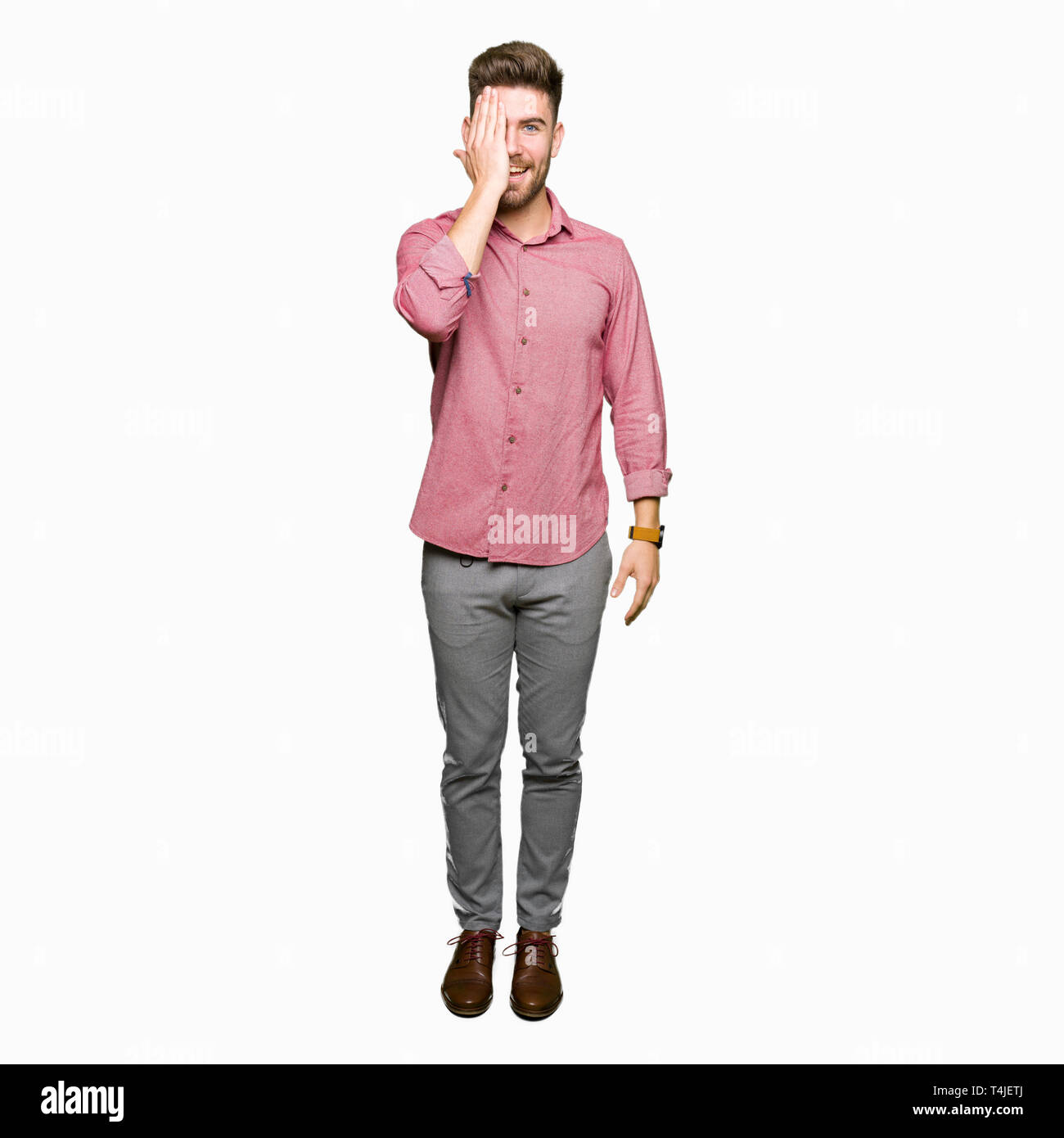 Young handsome business casual man covering one eye with hand with ...
