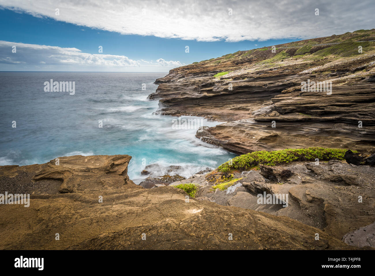 Ocean waves swirling around the unique lava rock formations of the Lanai Lookout on Oahu, Hawaii Stock Photo