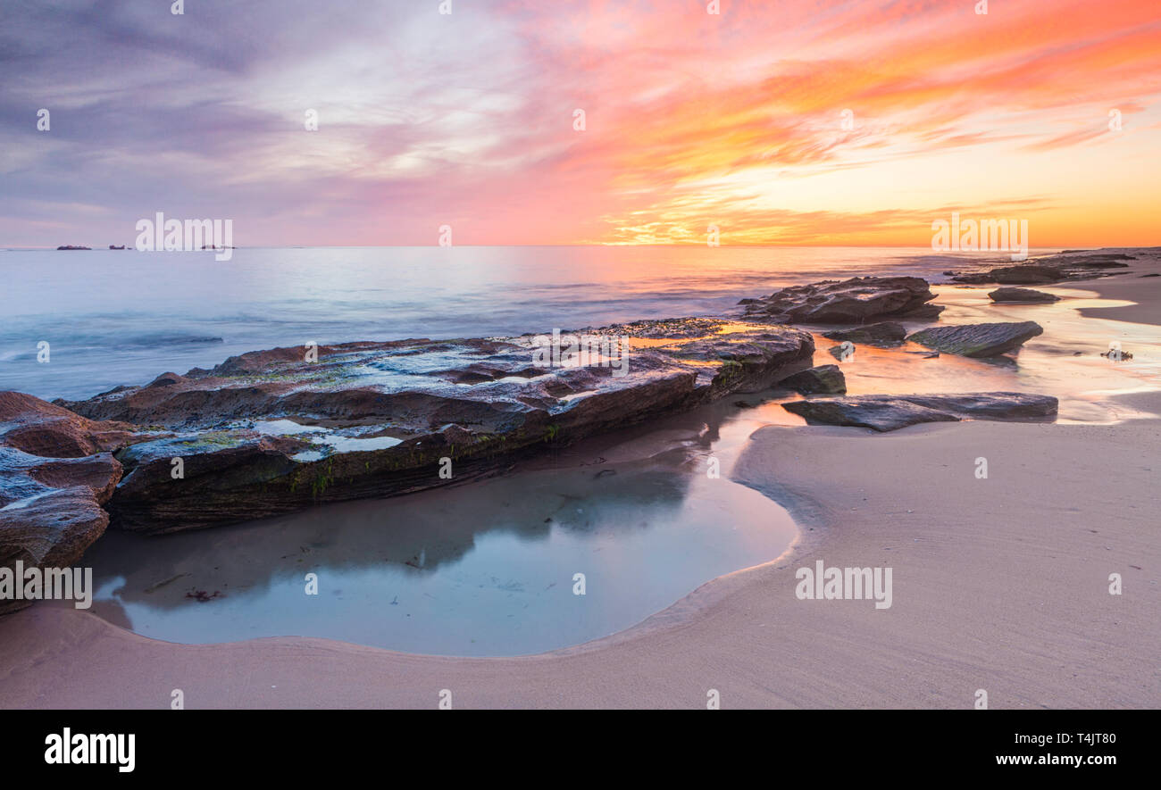 Limestone coastline and rock pools at Burns Beach at sunset. Perth, WA Stock Photo