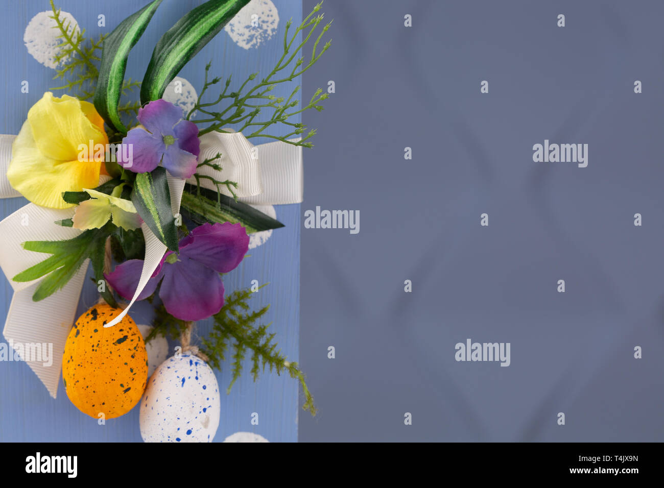 Happy Easter. Congratulatory easter background. Easter eggs and flowers. Copy space Stock Photo