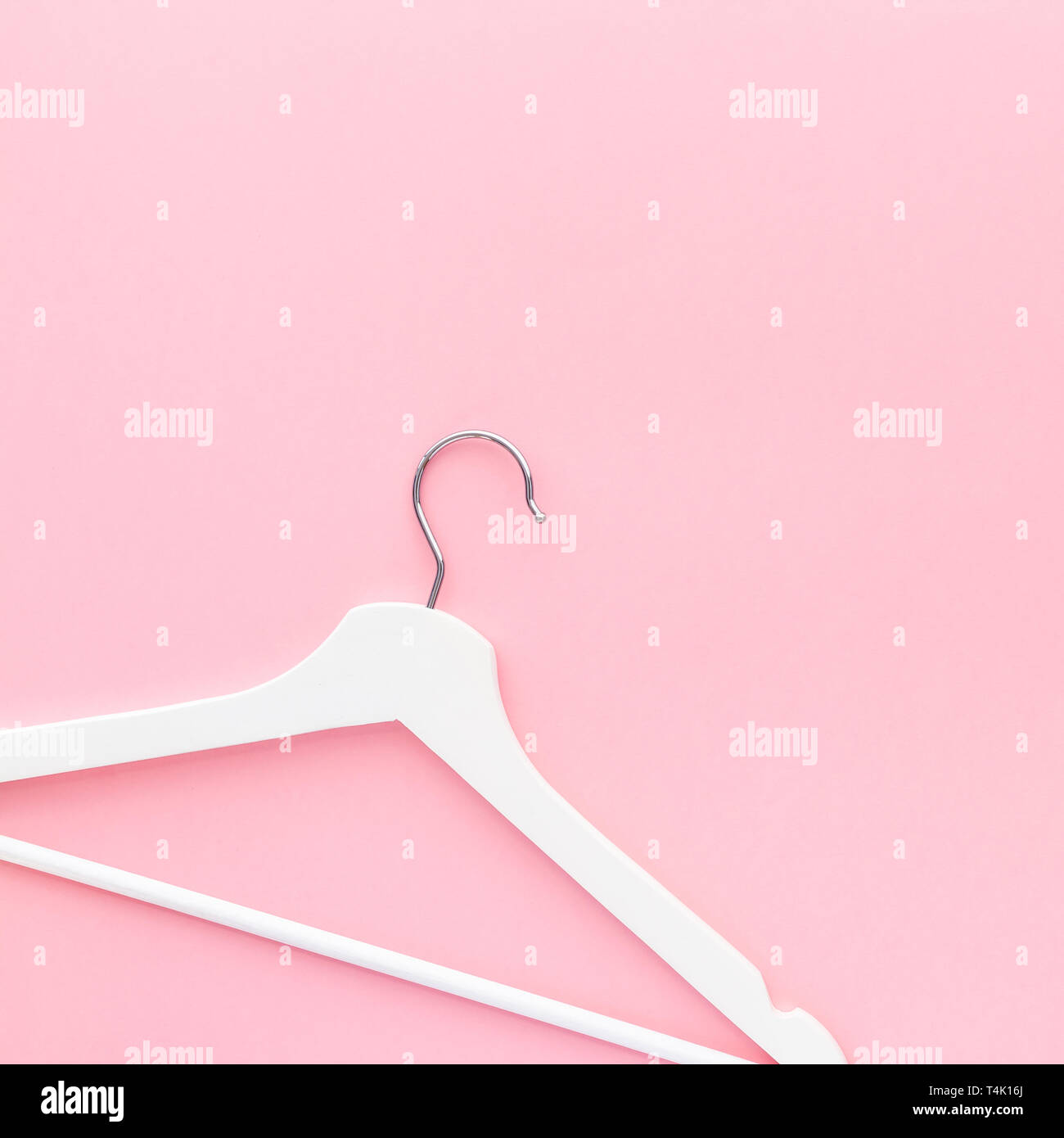 Creative top view flat lay white wooden hangers pastel millennial pink ...