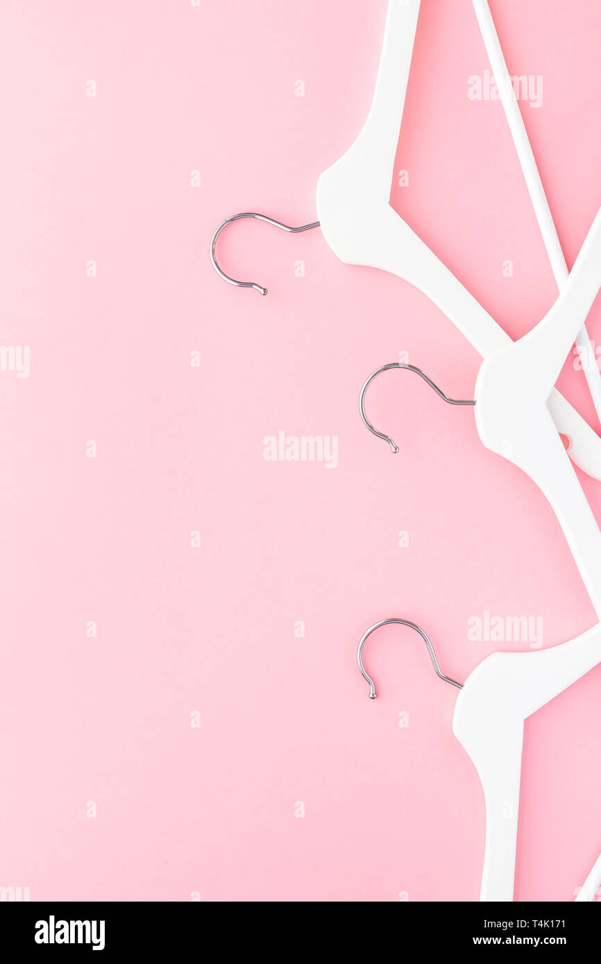 Creative top view flat lay white wooden hangers pastel millennial pink ...