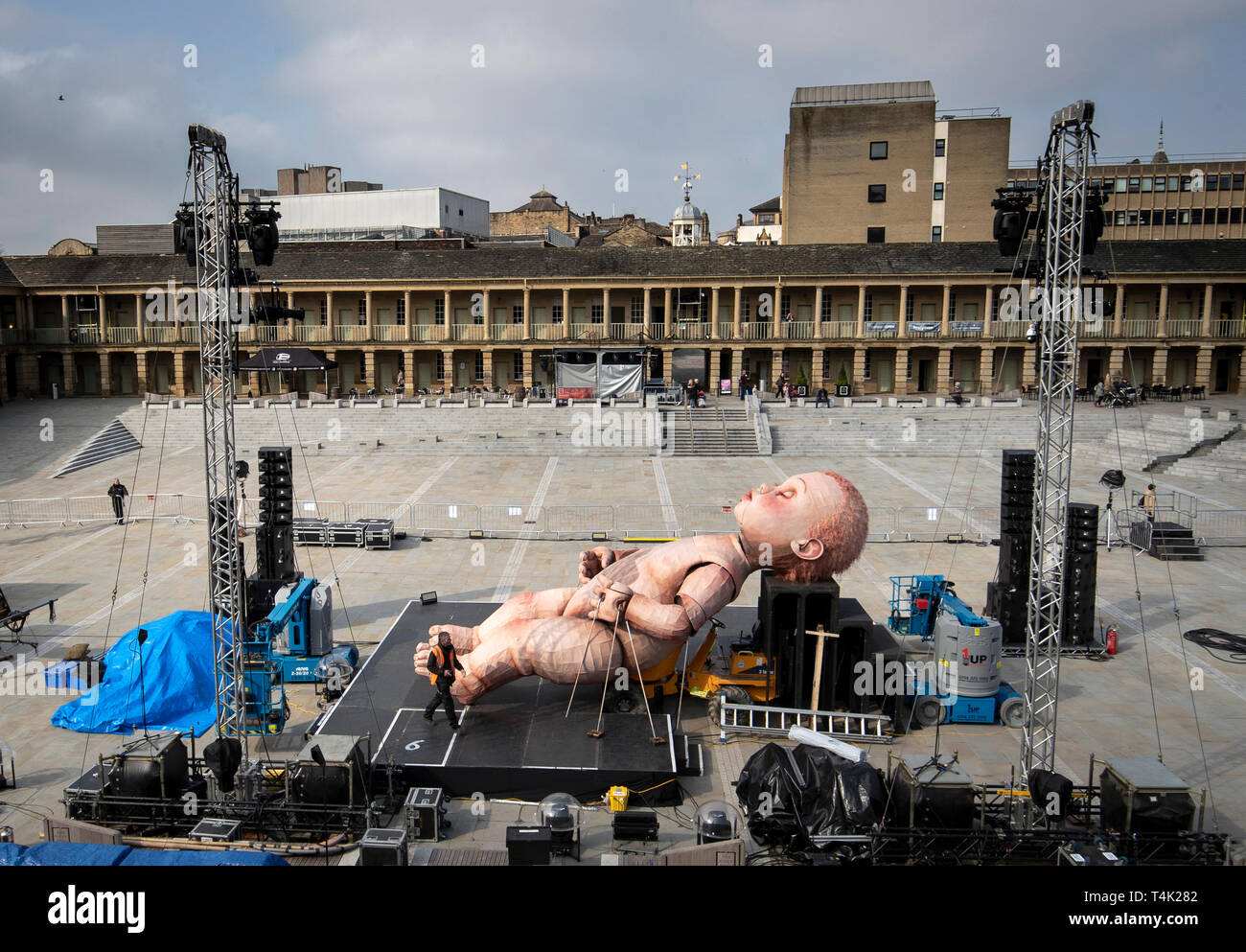 A giant mechanical baby is installed ahead of Mind the Gap Theatre  Company's first performance of ZARA at the Halifax Piece Hall, Yorkshire  Stock Photo - Alamy