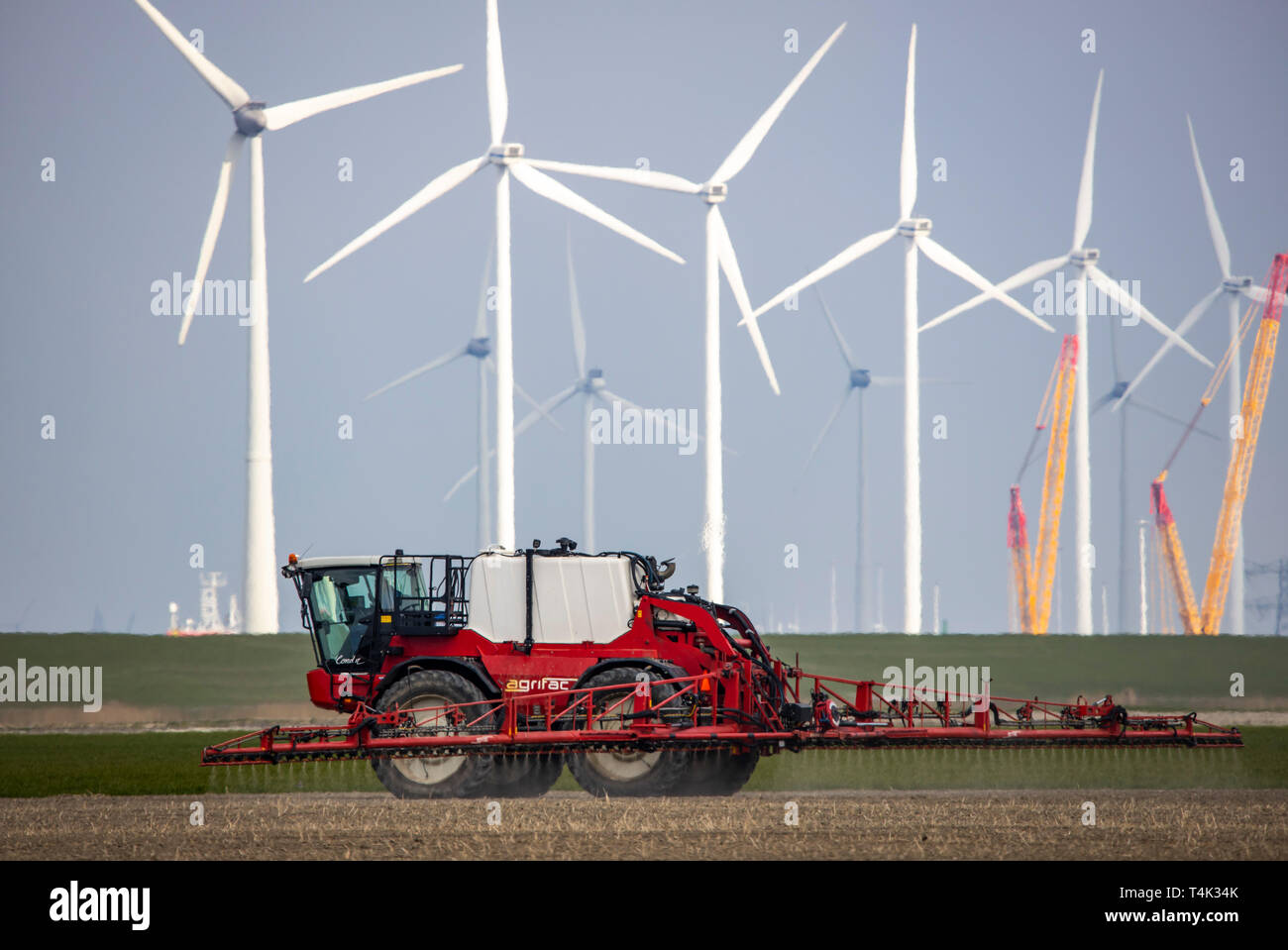Spreading of plant protection products on fields, at the Eemshaven seaport in the northwest, wind farm Westereems, the Netherlands, province Groningen Stock Photo