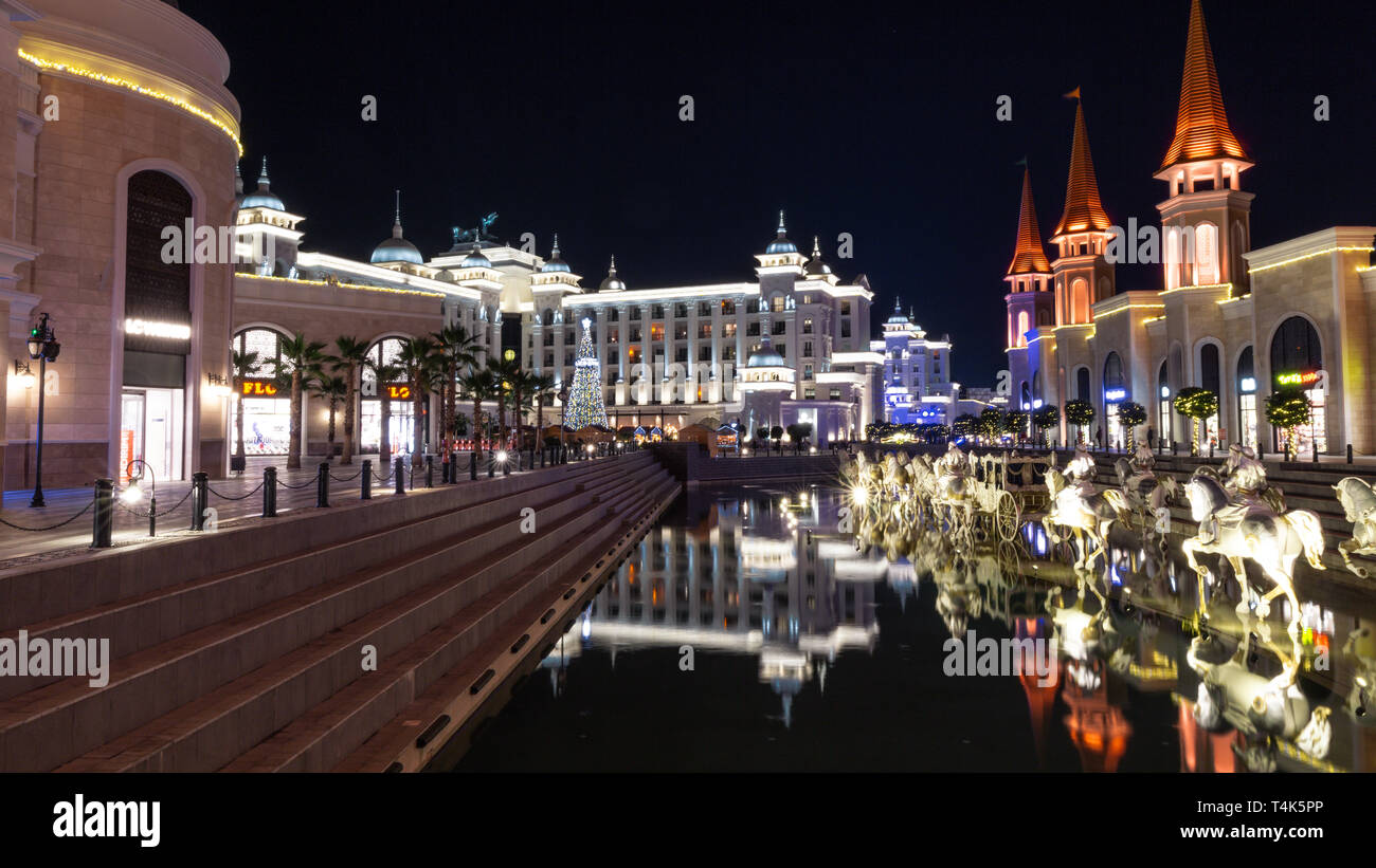 Belek, Turkey - 1st December 2018: Main pool with statues in Land of Legends theme mall. Night.A very big hotel, shopping mall and fun park. Stock Photo