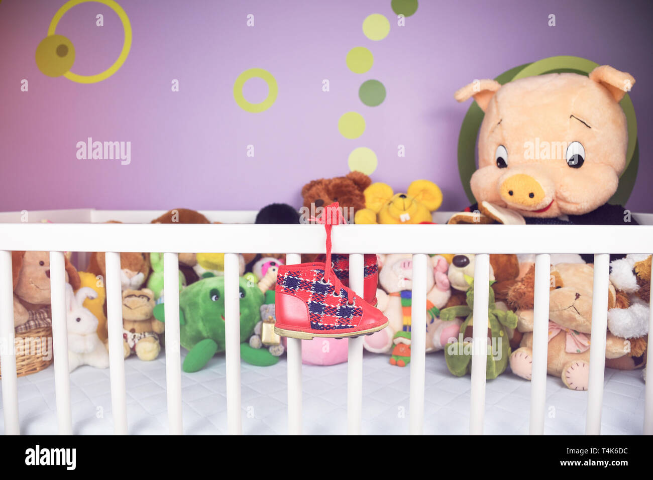 Group of colorful fluffy stuffed animal toys closeup with hanging red