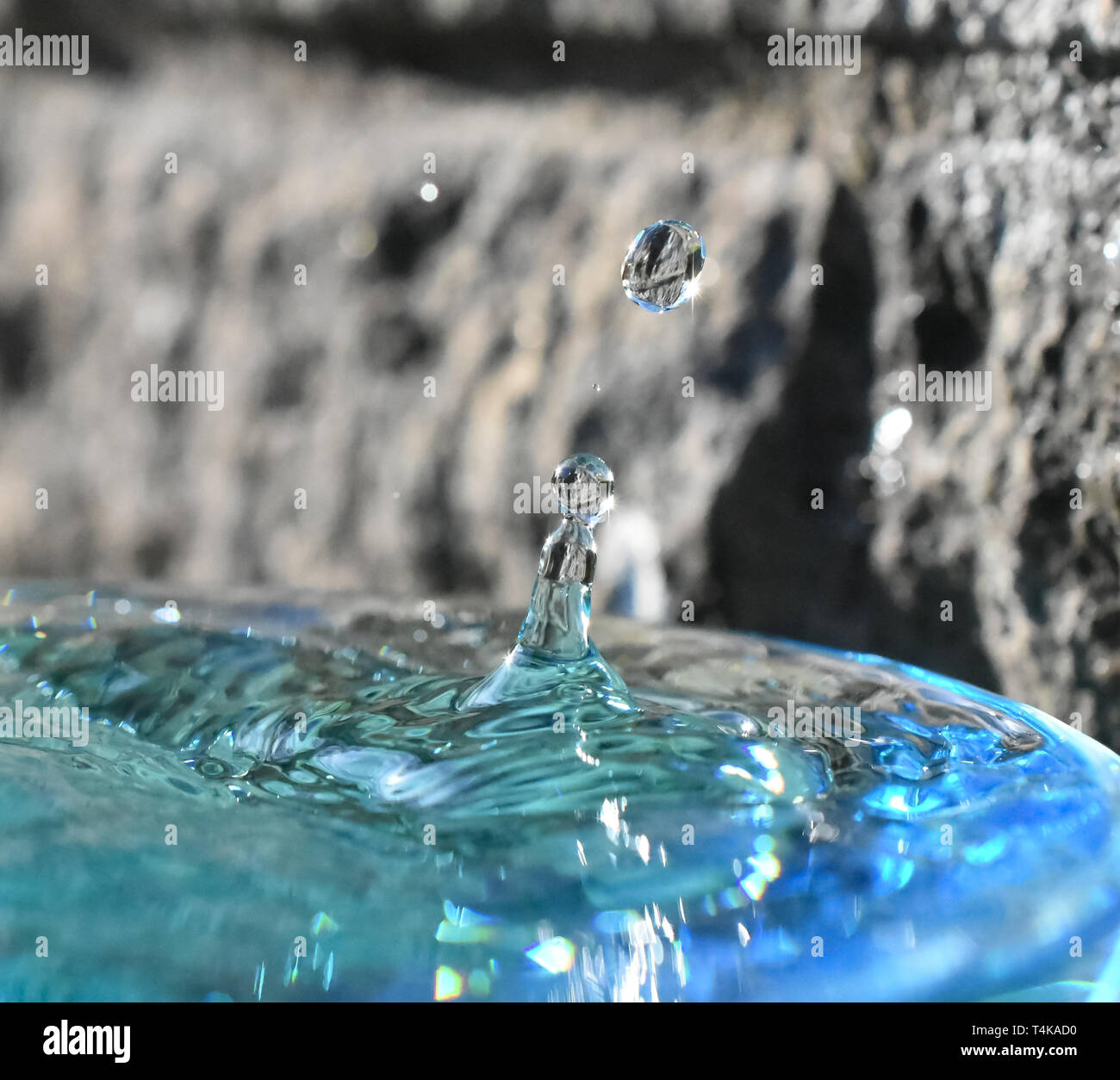Water droplet formation showing reflections in the sun Stock Photo Alamy