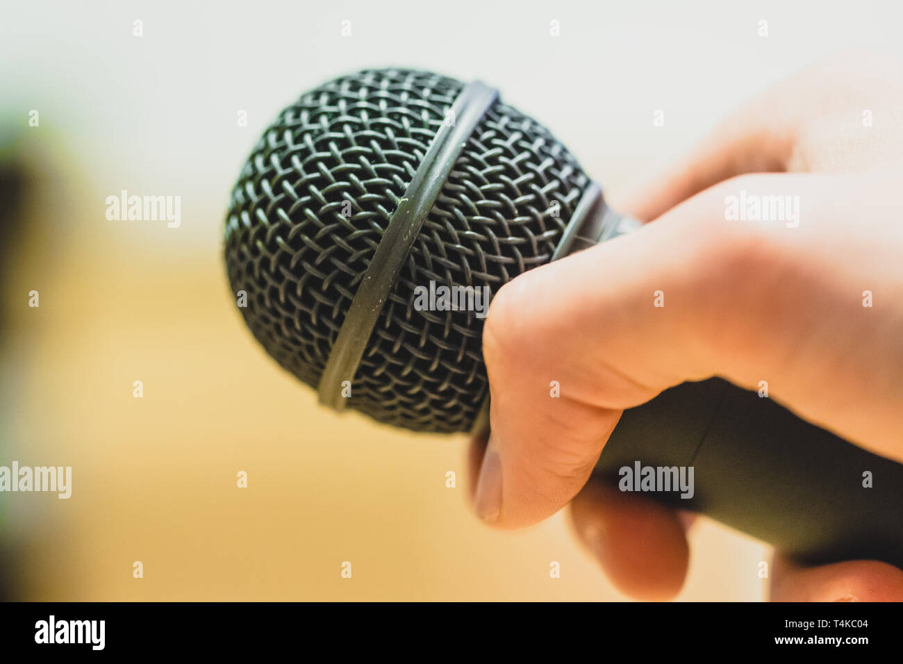 Close up picture of a hand which is holding a black microphone Stock ...