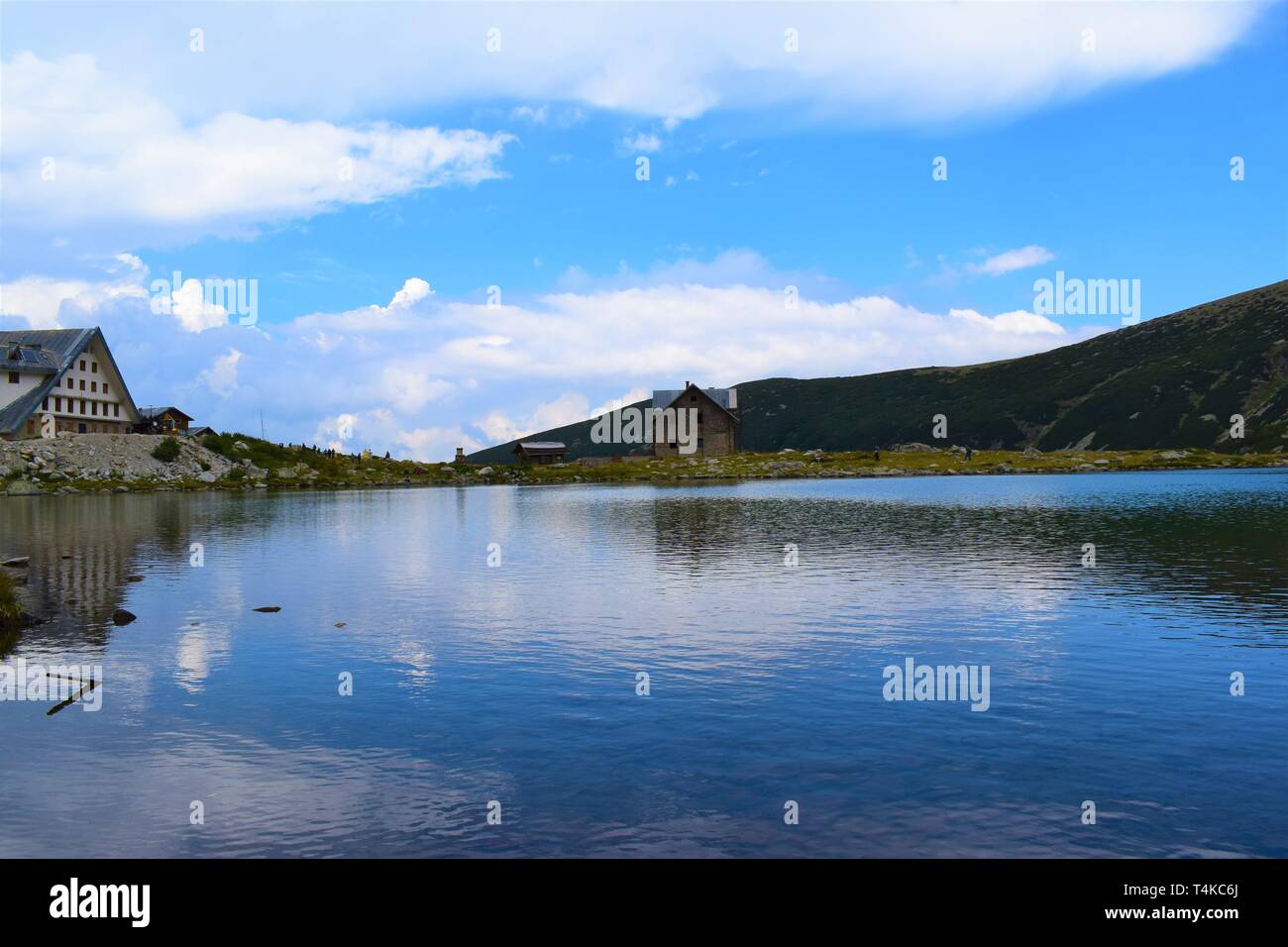 A beautiful lanscape near the highest peak in Balkan peninsula, Musala peak - a mountain with two cabins on the background and a lake in front of them Stock Photo